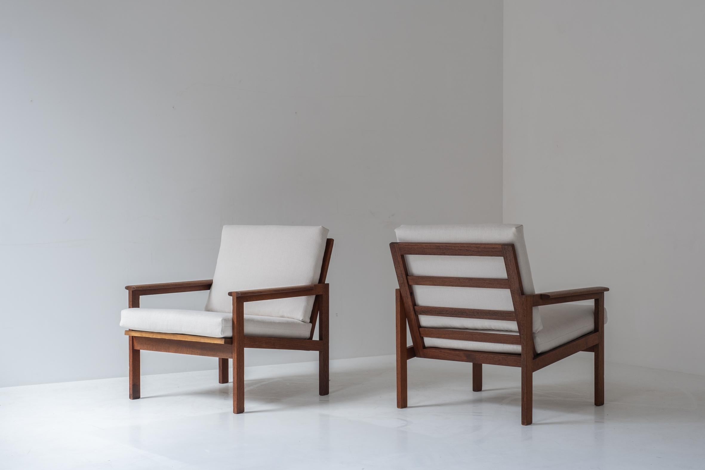 Set of two easy chairs designed by Illum Wikkelsø for N. Eilersen, Denmark 1959. This is model N°4 Capella easy chair made out of a solid teak frame with a fresh wool blend upholstery by Jan Jan van Essche. Lovely elegant wood joinery on the