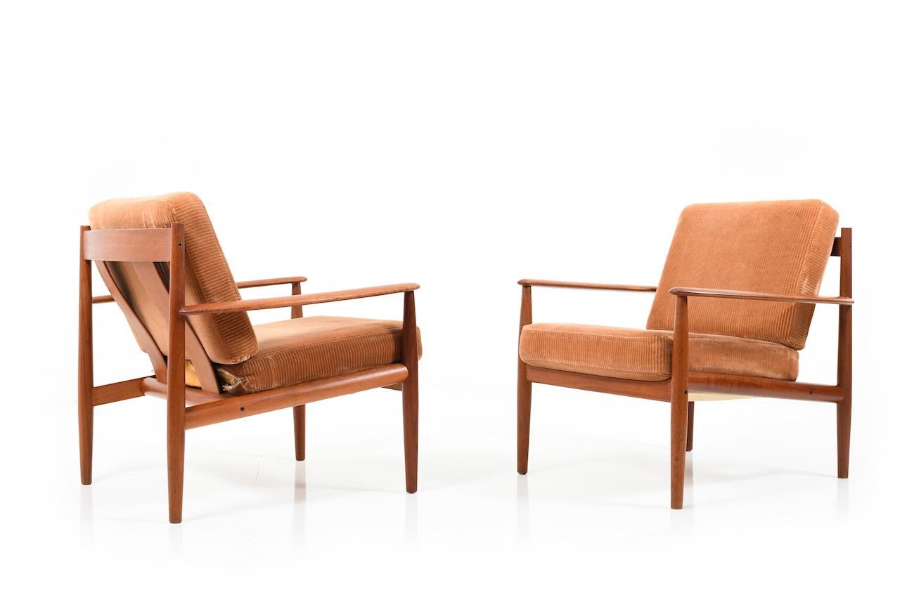 Two easy chairs in teak, model 118. Designed in 1962 by Grete Jalk (born in Denmark 1920). Manufactured France & Son in 1960's. Cushion in original orange/brown corduroy.
Note: These are 2 armchairs of the model 118 by Grete Jalk. Only the type of