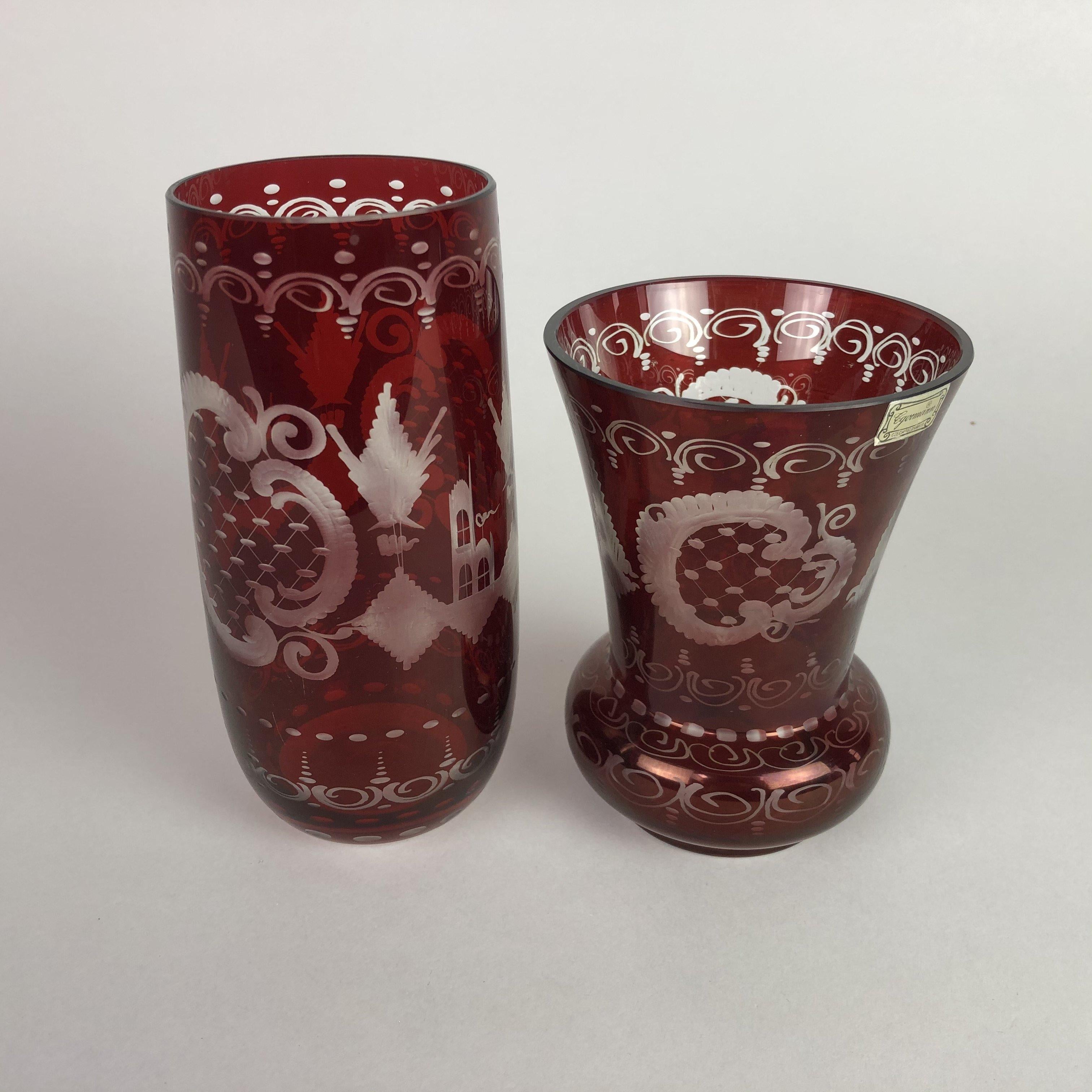 Set of two vintage handmade and handcut to clear etched glass vases. Beautiful ruby red coloured Czech vases from the 1940s. 
One vase is 18 cm (7.1 inch) high and the other one is 14.5 (5.7 inch) cm high.