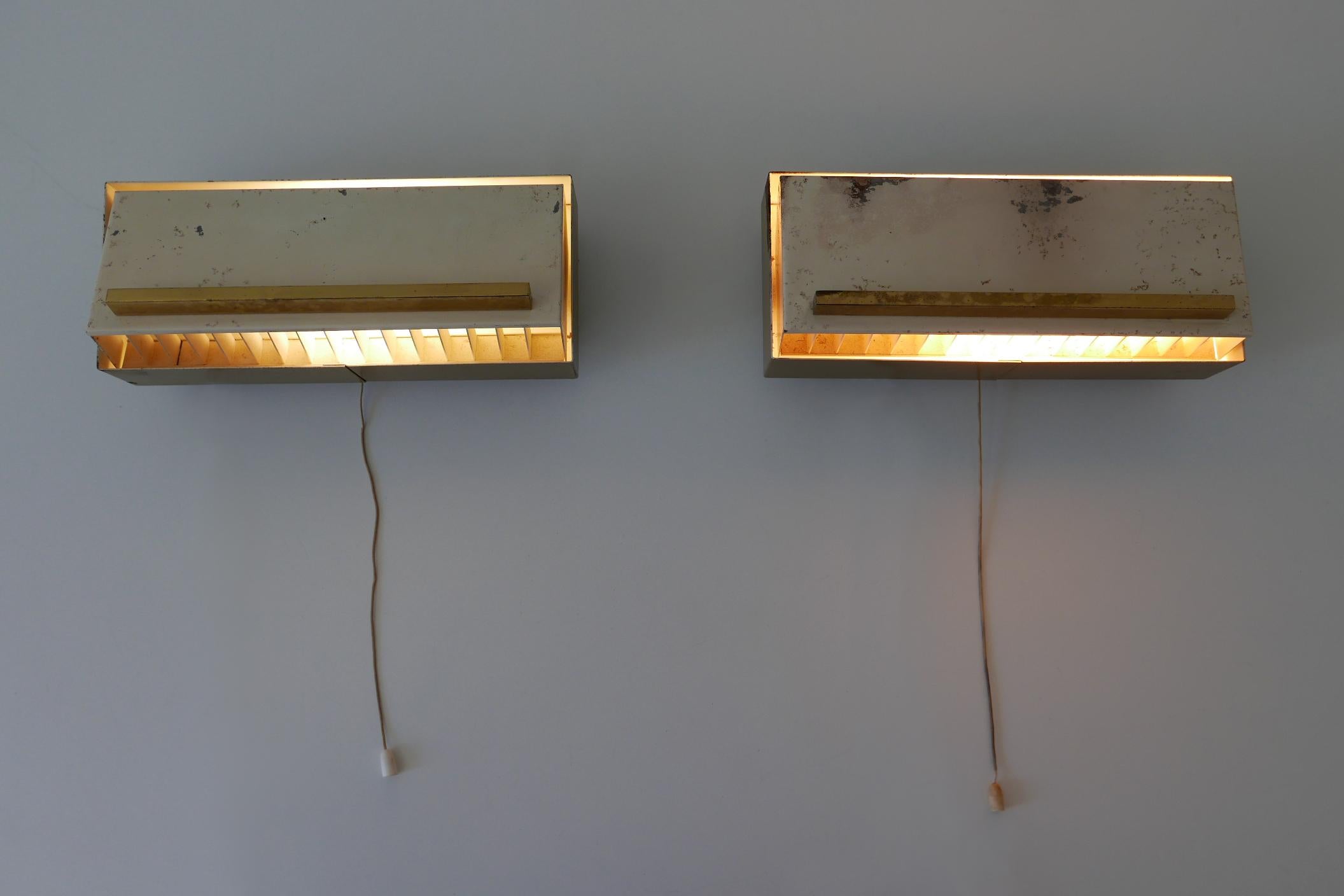 Set of two rare and elegant Mid-Century Modern bedside sconces or wall lamps with adjustable shades. Designed and manufactured by Paul Neuhaus Leuchten, Germany, 1950s.

Executed in brass and enameled metal, each lamp needs 1 x E14 / E12 Edison