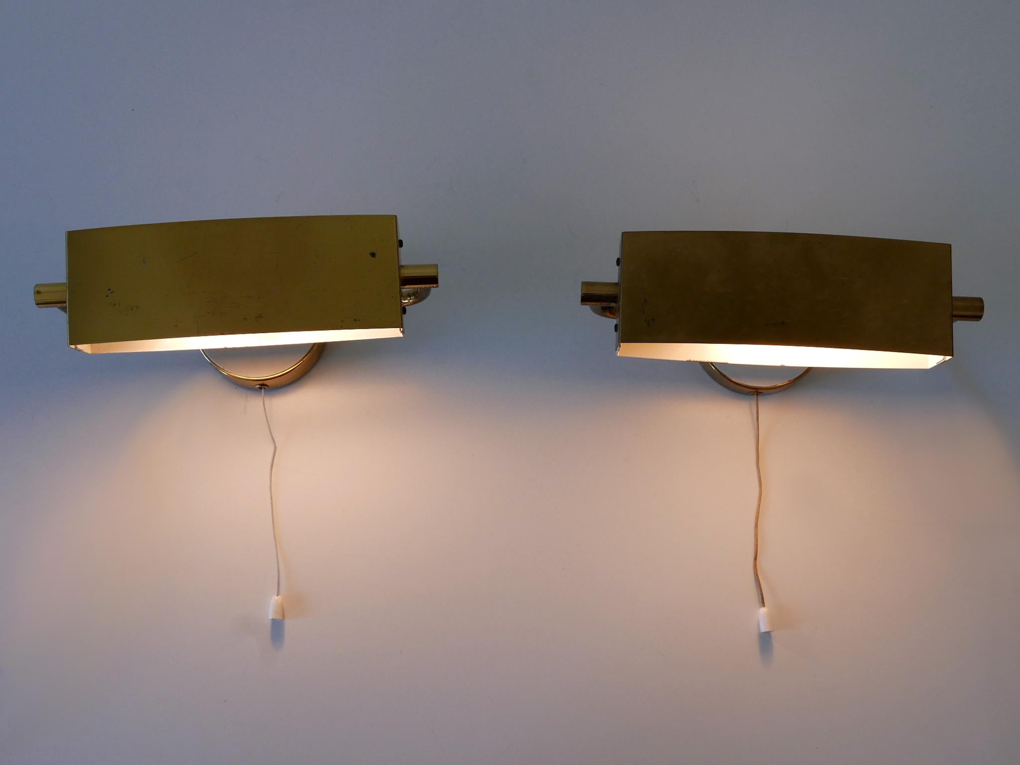 Set of two elegant Mid-Century Modern wall lights / sconces with rotating shades. Down and up lighter. Designed and manufactured by Paul Neuhaus Leuchten, Germany, 1950s.

Executed in brass and enameled metal, each lamp comes with 1 x E14 / E12