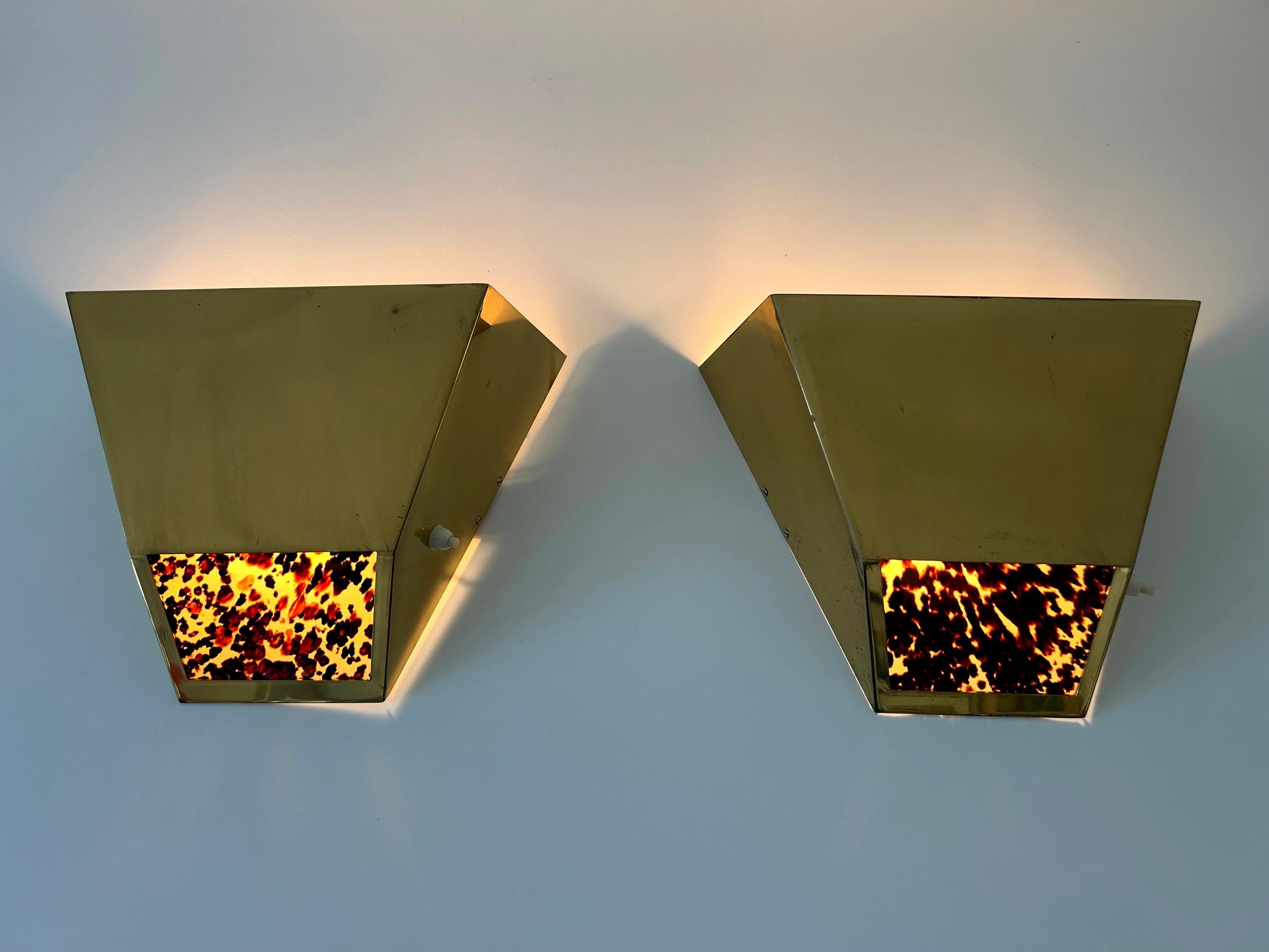 Set of two exceptional, large,  elegant highly decorative Mid-Century Modern brass sconces or wall fixtures. Designed & manufactured by Vereinigte Werkstätten, Germany, 1970s.

Executed in solid brass sheet, each fixture comes with 1 x E27 / E26