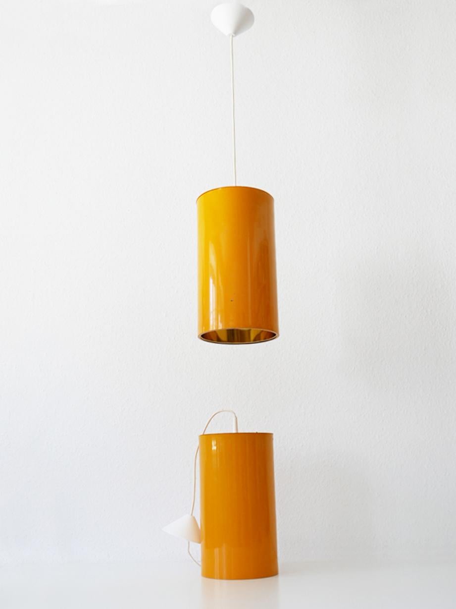 Rare and elegant Mid-Century Modern pendant lamps or hanging lights. Designed and manufactured by Erco, 1970s, Germany.

Executed in orange lacquered aluminium and metal, each lamp comes with 1 x E27 Edison screw fit bulb holder, is wired and in