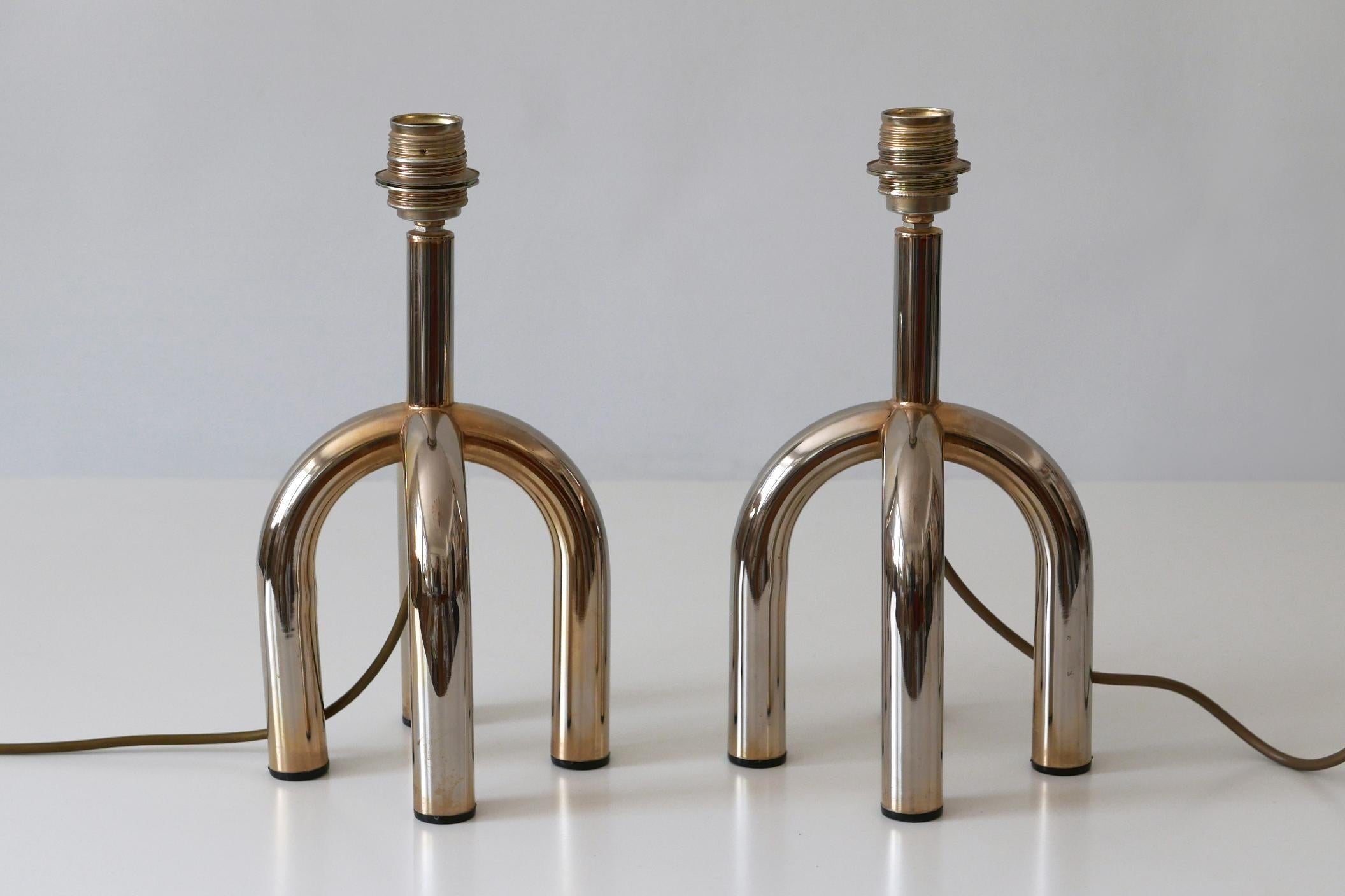 Set of two rare and beautiful Mid-Century Modern four-legged table lamps. Manufactured in Germany, 1970s.

Executed in nickel-plated metal, each lamp comes with 1 x E27 / E26 Edison screw fit bulb holder, is wired, in working condition and runs both