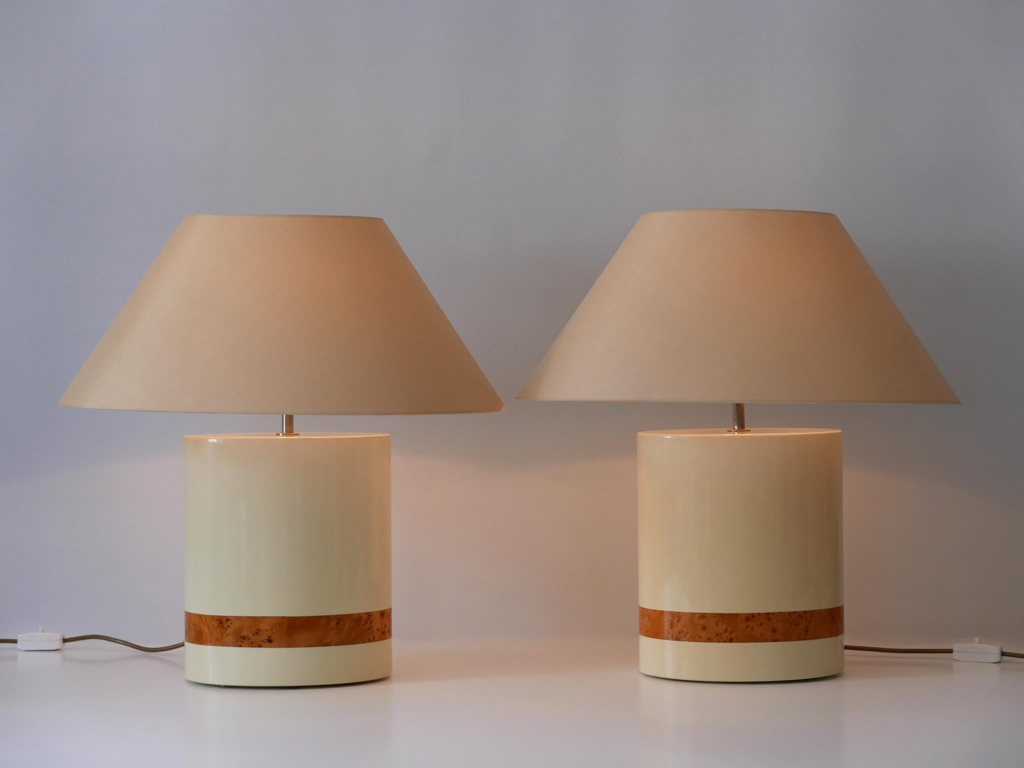 Set of two rare and beautiful Mid-Century Modern table lamps. Designed by Tommaso Barbi, Italy, 1970s. Label under the base.

Executed in creme colored plastic, metal and fabric, each lamp comes with 1 x E27 / E26 Edison screw fit bulb holder, is