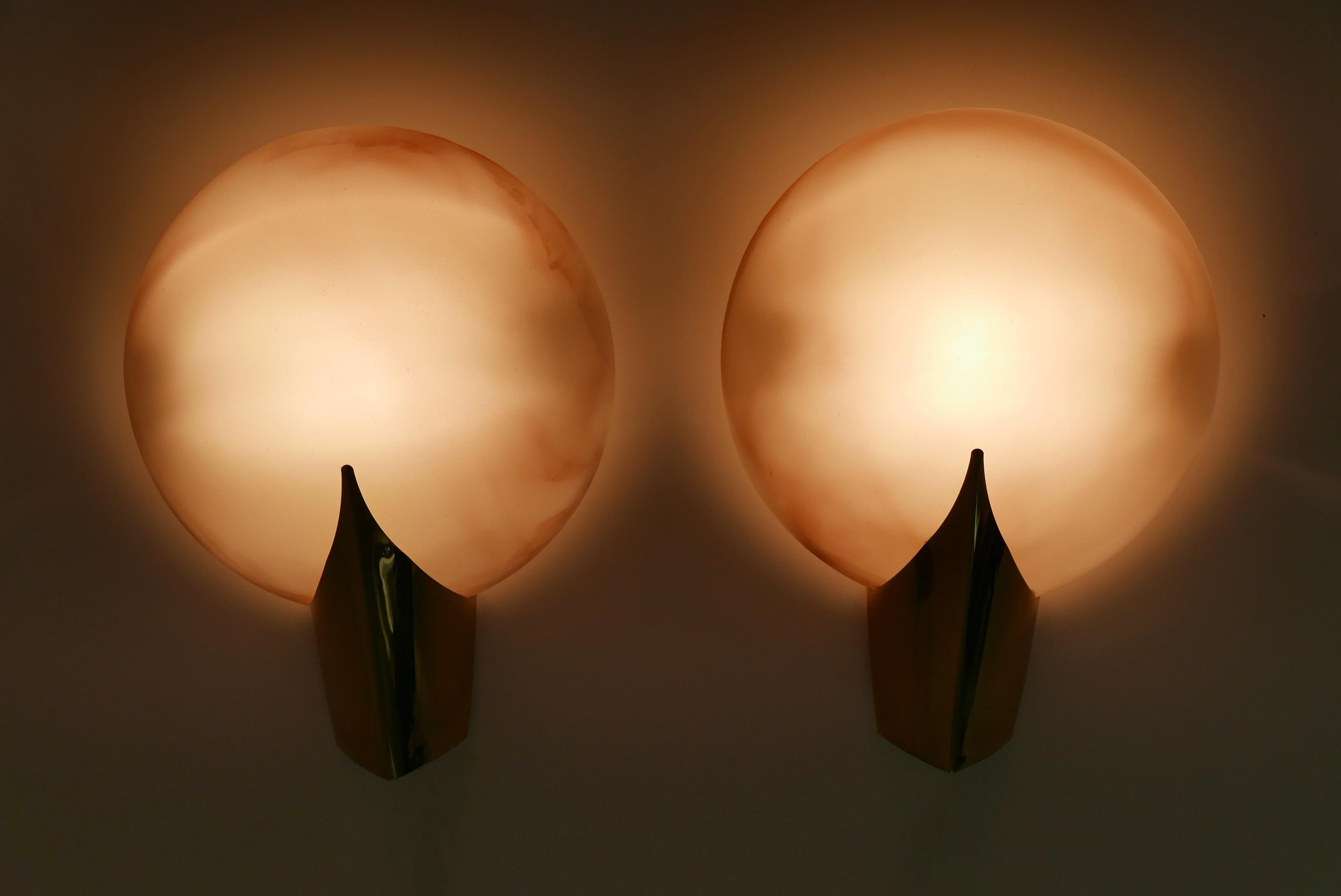 Set of two elegant wall lamps / sconces. Manufactured by J.T. Kalmar, 1980s, Vienna, Austria.

Executed in thick marbled glass, brass sheet and metal, each lamp needs 1 x halogen bulb. Max. 150 Watt. Delivery without bulbs. They run both on 110 /