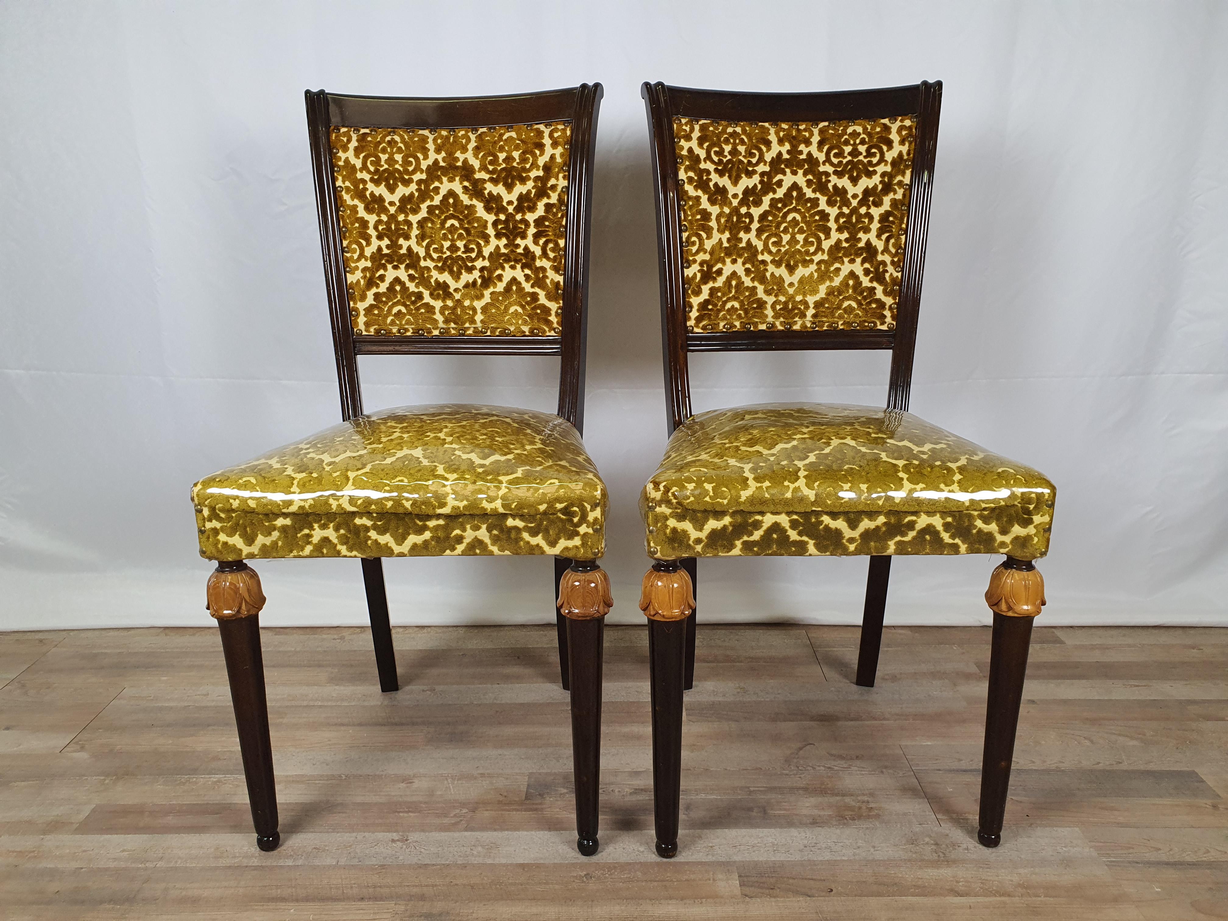 Pair of 1950s wooden chairs with backrest and seat in the original fabric of the time.

The wood has been polished, in the past they have been used very little as shown by the seats still protected with nylon as seen in the photos.
Normal marks