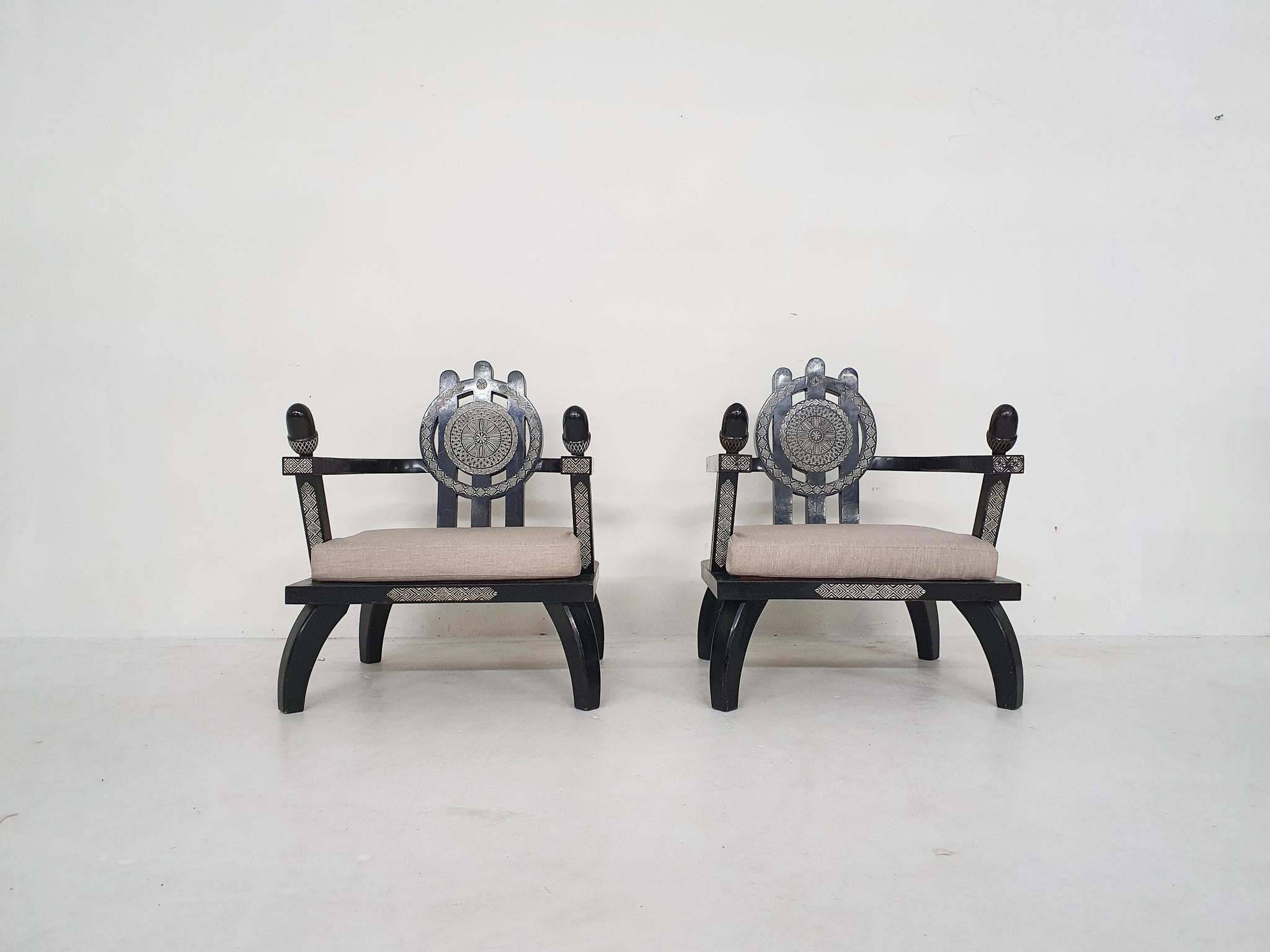 Set of two lounge chairs by Ettore Zaccari designed in the 1910's
Black wooden frame has some traces of use. The seating has the original springs with a South-American pattern. 
We had new cushions made with new off white fabric, which matches the