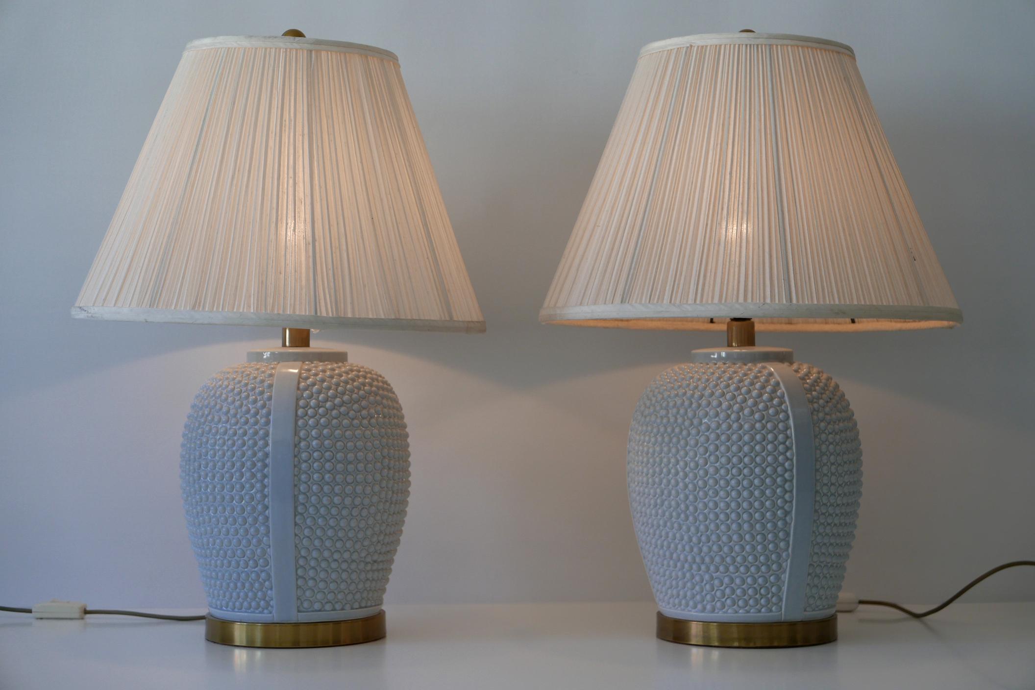 Set of two exceptional, elegant and large Mid-Century Modern ceramic table lamps. Designed and manufactured probably in 1960s, Germany.

Executed in ice-blue color glazed ceramic, brass and silk lamp shades, each lamp comes with 1 x E27 / 26 Edison