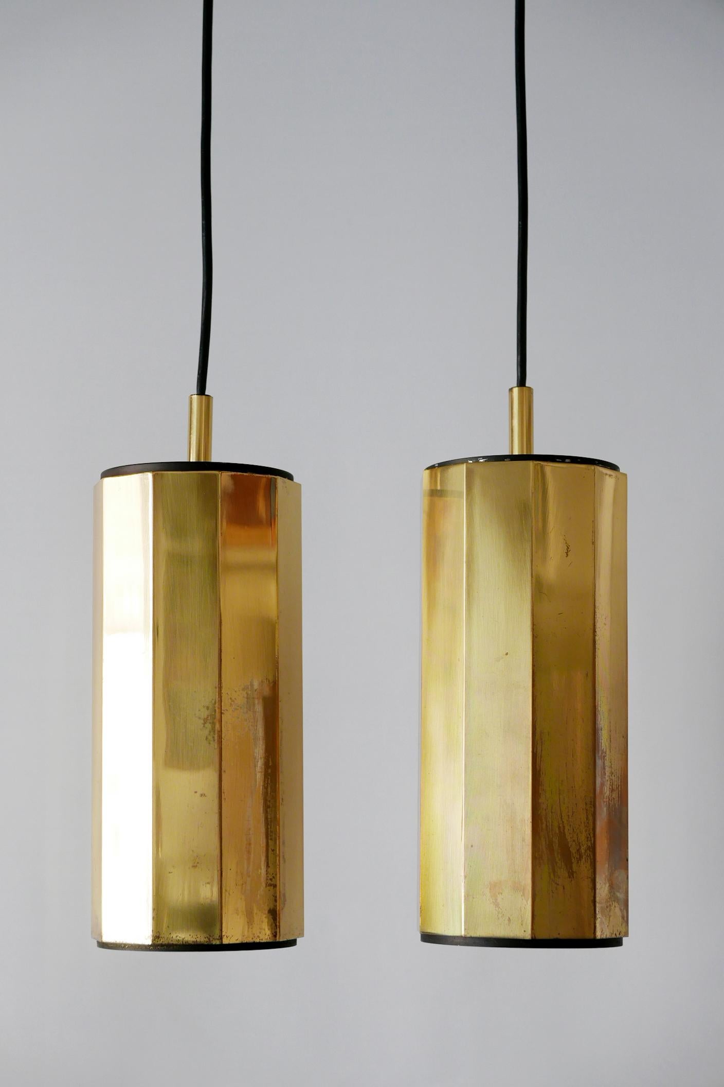 Set of two extremely rare and elegant Mid-Century Modern decagonal brass pendant lamps. Manufactured probably in Germany, 1960s.

The lamps are executed in brass and black lacquered metal. Each lamp needs 1 x E27/E26 Edison screw fit bulb. They