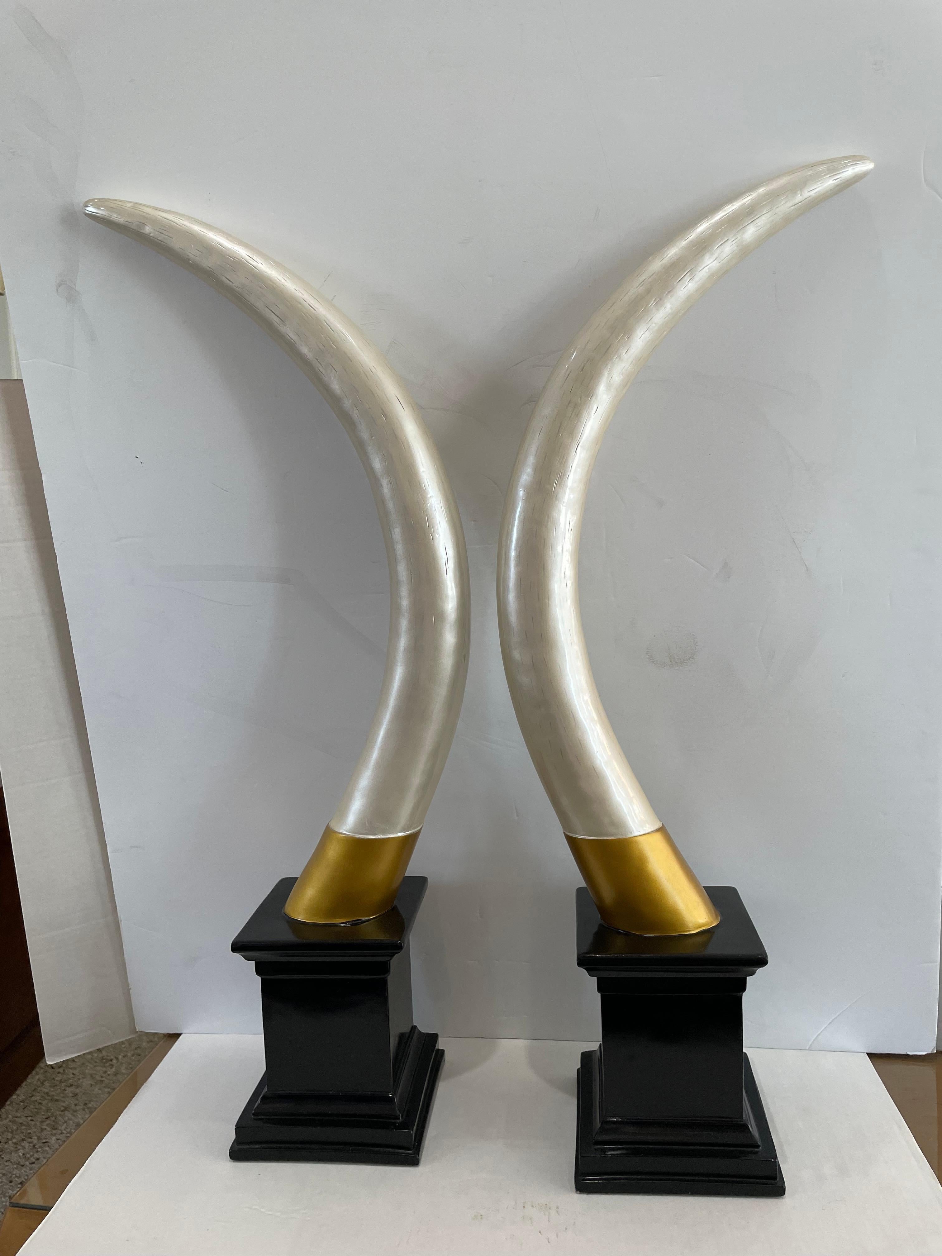 This stylish and chic set of faux elephant tusk date to the late 1990s and are very much in the manner of the Hollywood Regency period.  And the pieces are very much in the manner of pieces created by Maitland Smith.

Note: There is no makers mark
