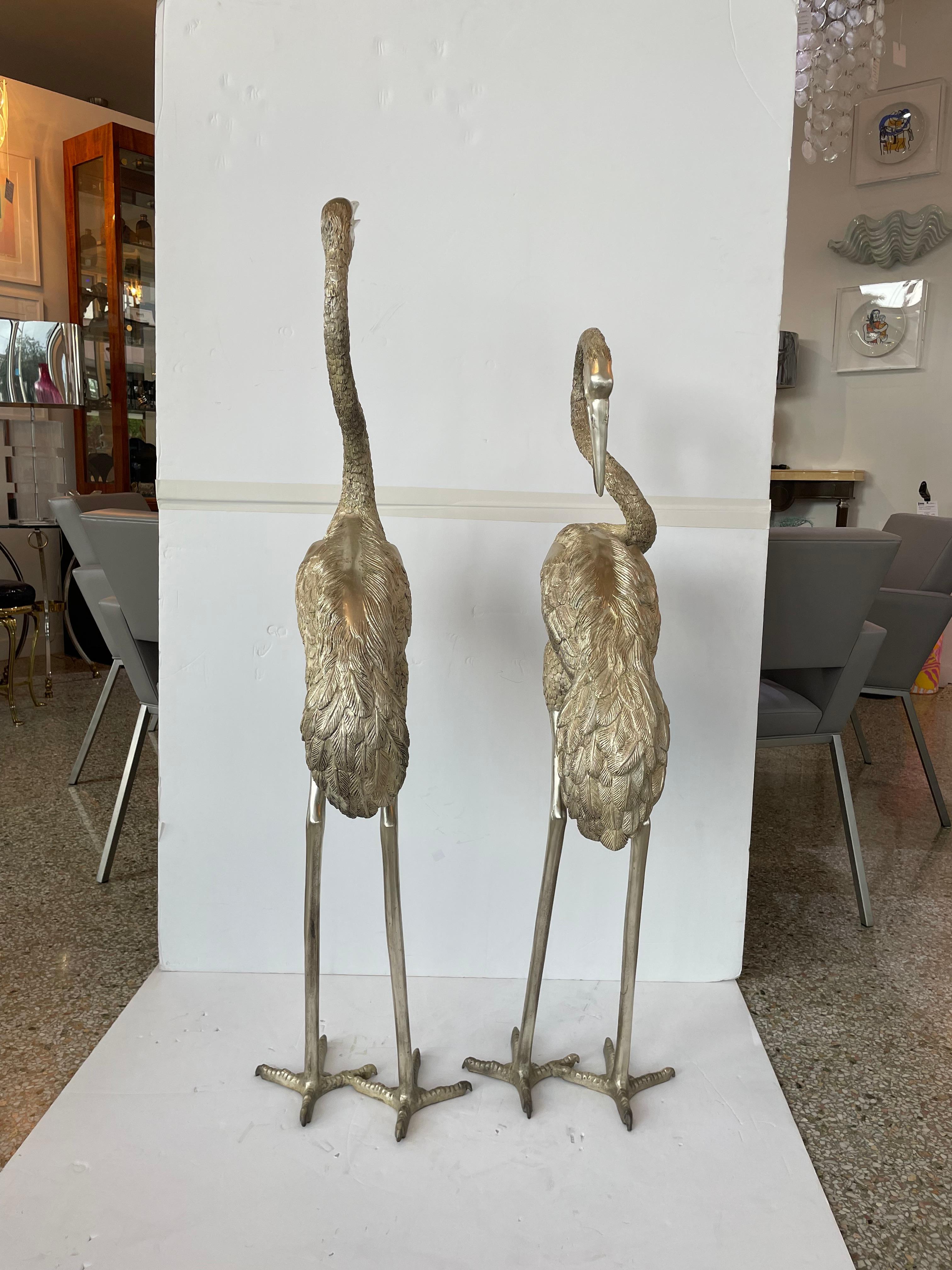 This stylish and chic set of two life size cranes will make a statement in your garden with their form and use of materials.  The pieces are cast bronze with a patinated nickel plating that catches the light beaufitully and dramaticly. 

Note: