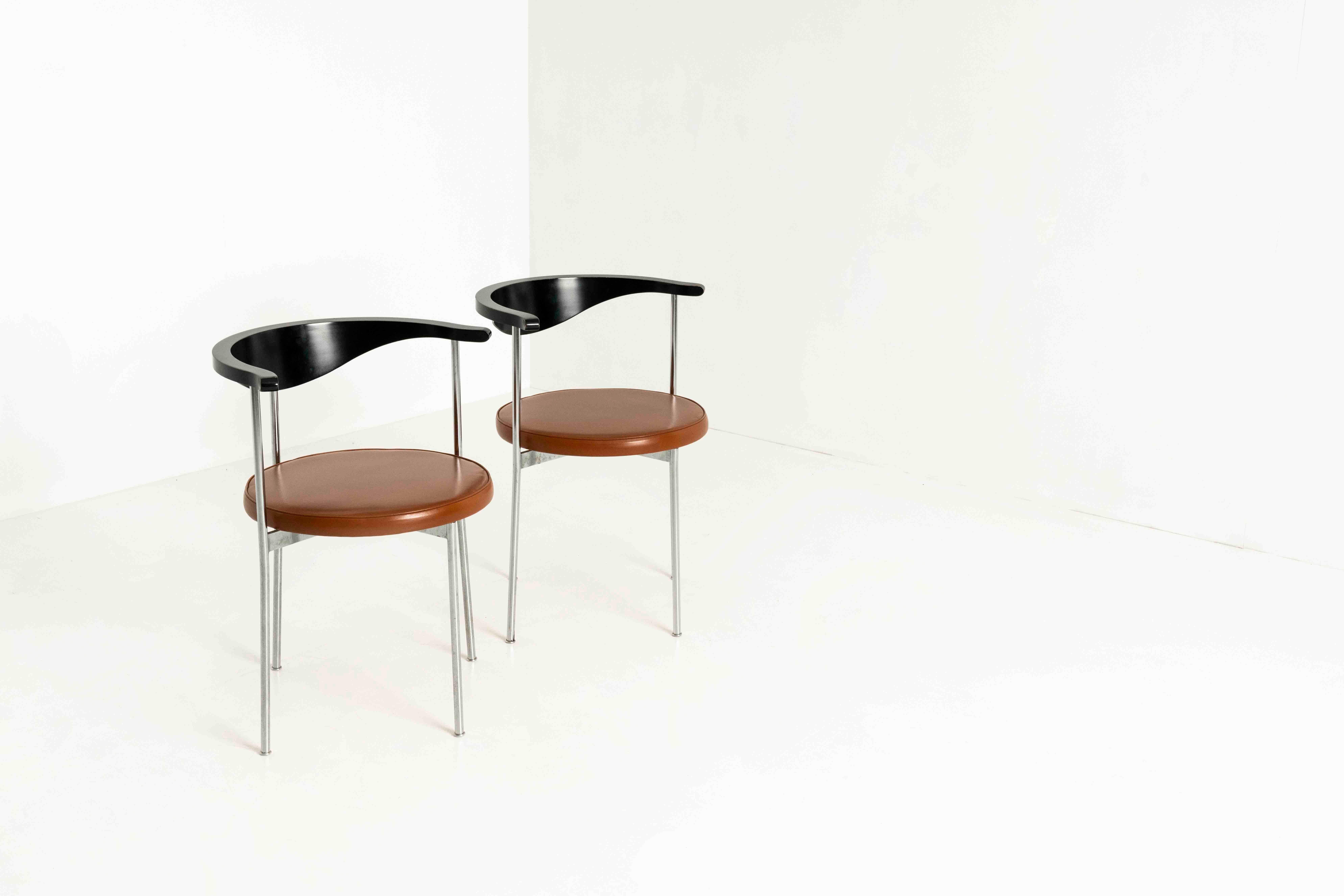 Set of Two Frederick Sieck chairs for Fritz Hansen from Denmark, the 1960s. These chairs, with model 3200, have a tan leather seating area and a black-colored back that is nicely shaped. The base is of steel. The chair has an outward curving top