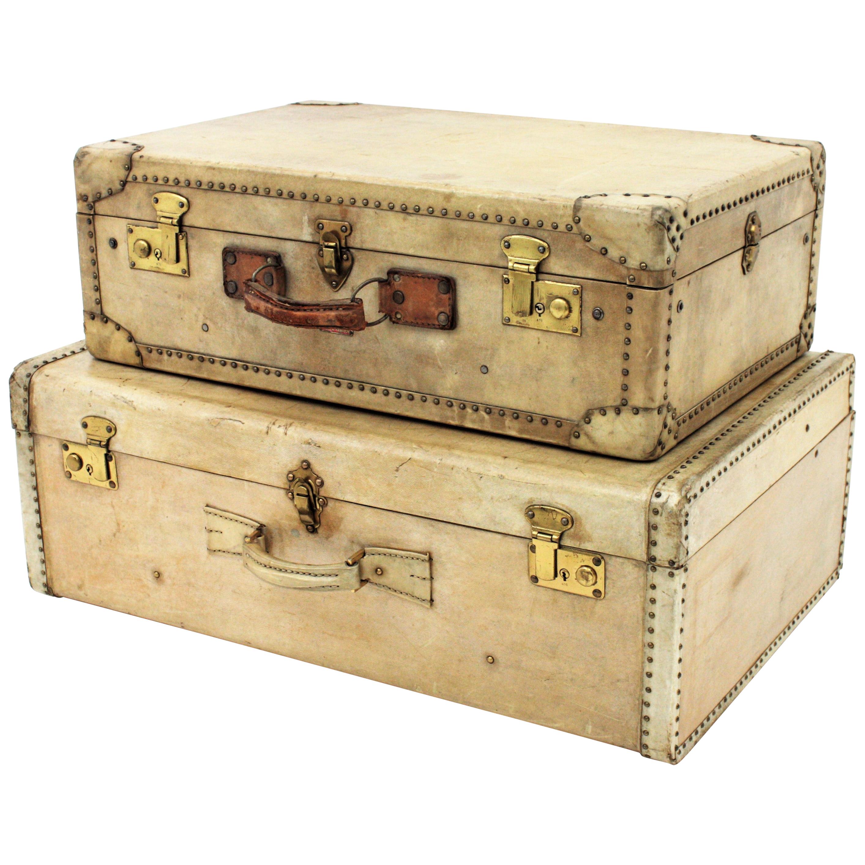 A set of high quality French luxury vellum suitcases. France, 1920-1930s.
Made in wood and parchment with brass studs and lock plates in brass and leather handles.
The one on the top was manufactured by Innovation.
The one on the bottom comes from