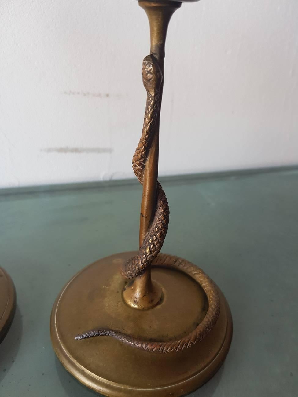Set of two lovely Minimalist design French bronze candlesticks decorated with a snake curling around the stem 19th century.

The measurements are,
Depth 9 cm/ 3.5 inch.
Width 9 cm/ 3.5 inch.
Height 18.5 cm/ 7.2 inch.