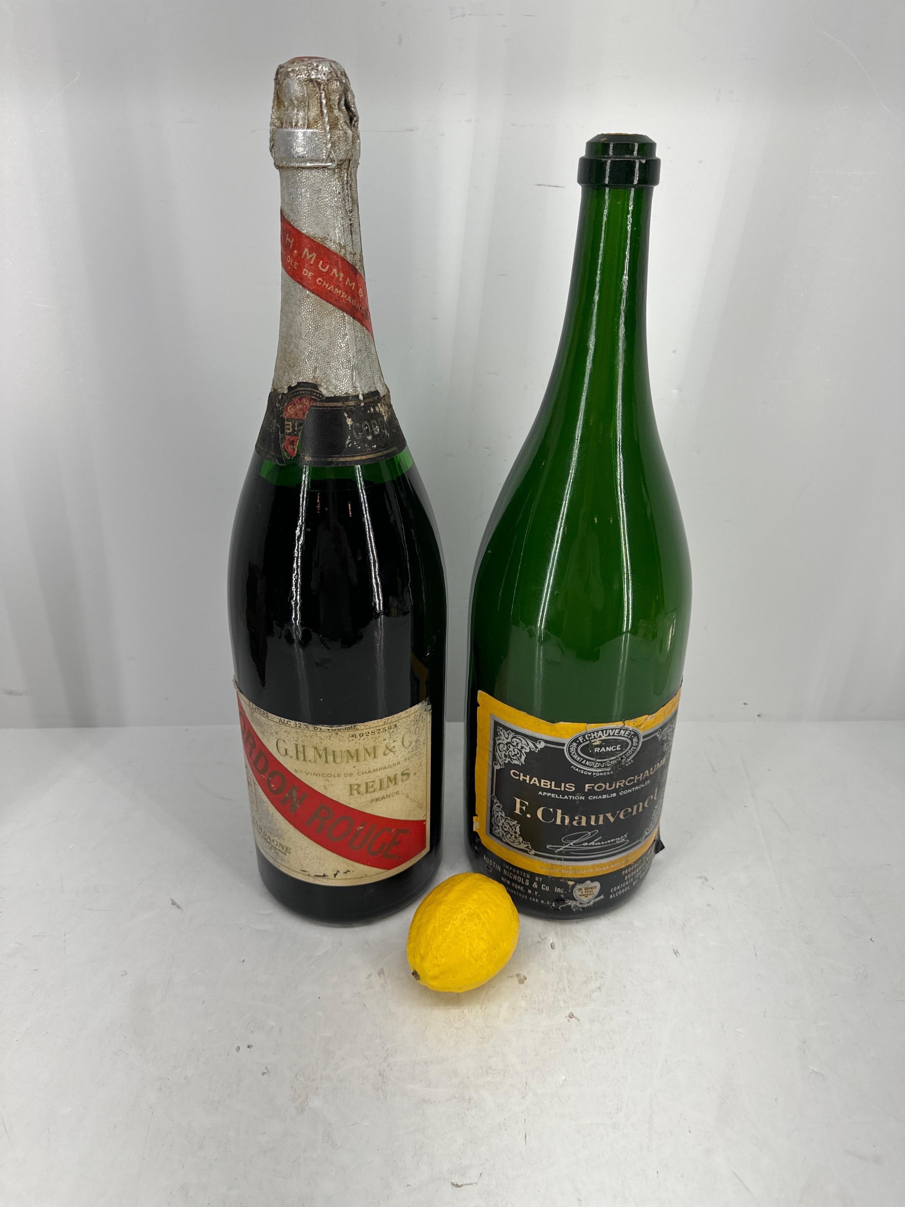 Two Oversized Bottles from Gordon Rouge GH Mumm and Co. and Francoise E. Chauvenet. These vintage bottles are perfect for display either in a home or on a bar in a store or restaurant setting. Please note one bottle is intact, never opened. 

 