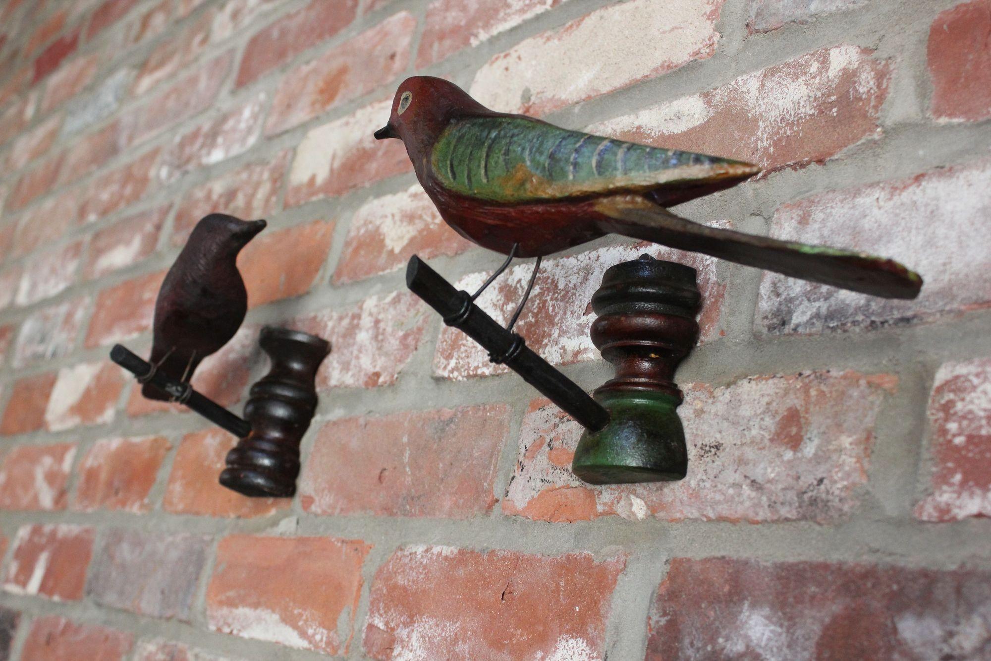 Set of two antique bird sculptures from Germany's Black Forest, ca. early 20th Century.
Composed of delicately hand-carved avian forms each hand-painted with attractive colors and unique details with wire legs perched on carved tree limbs attached