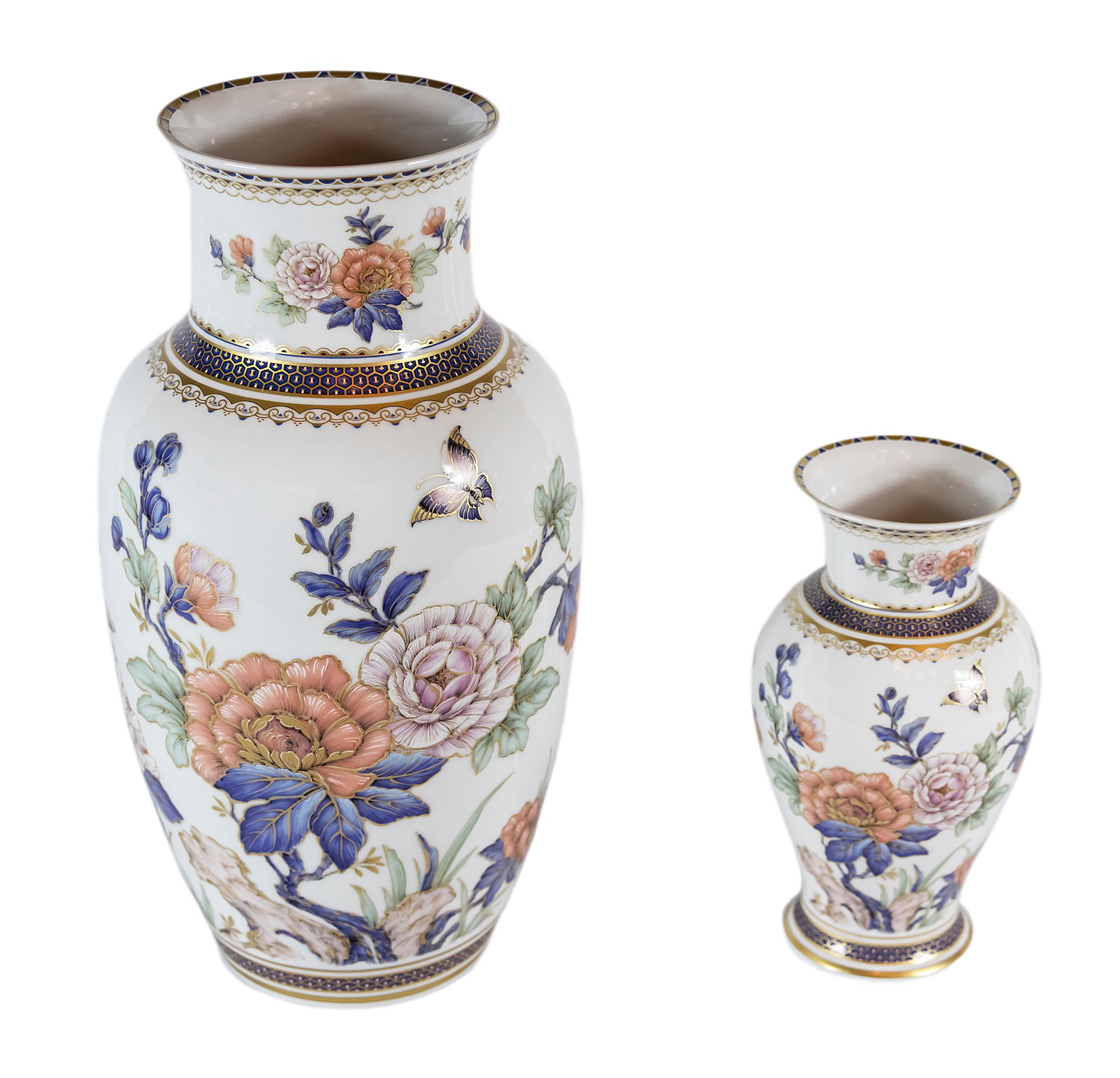 Set of two vases created by Kaiser Porcelain manufactory in 1950s.
Measures: Large vase H 38 cm x 20 cm, small vase H 22 x 13 cm.
Both vases are hand painted with floral decor in the oriental style.

   