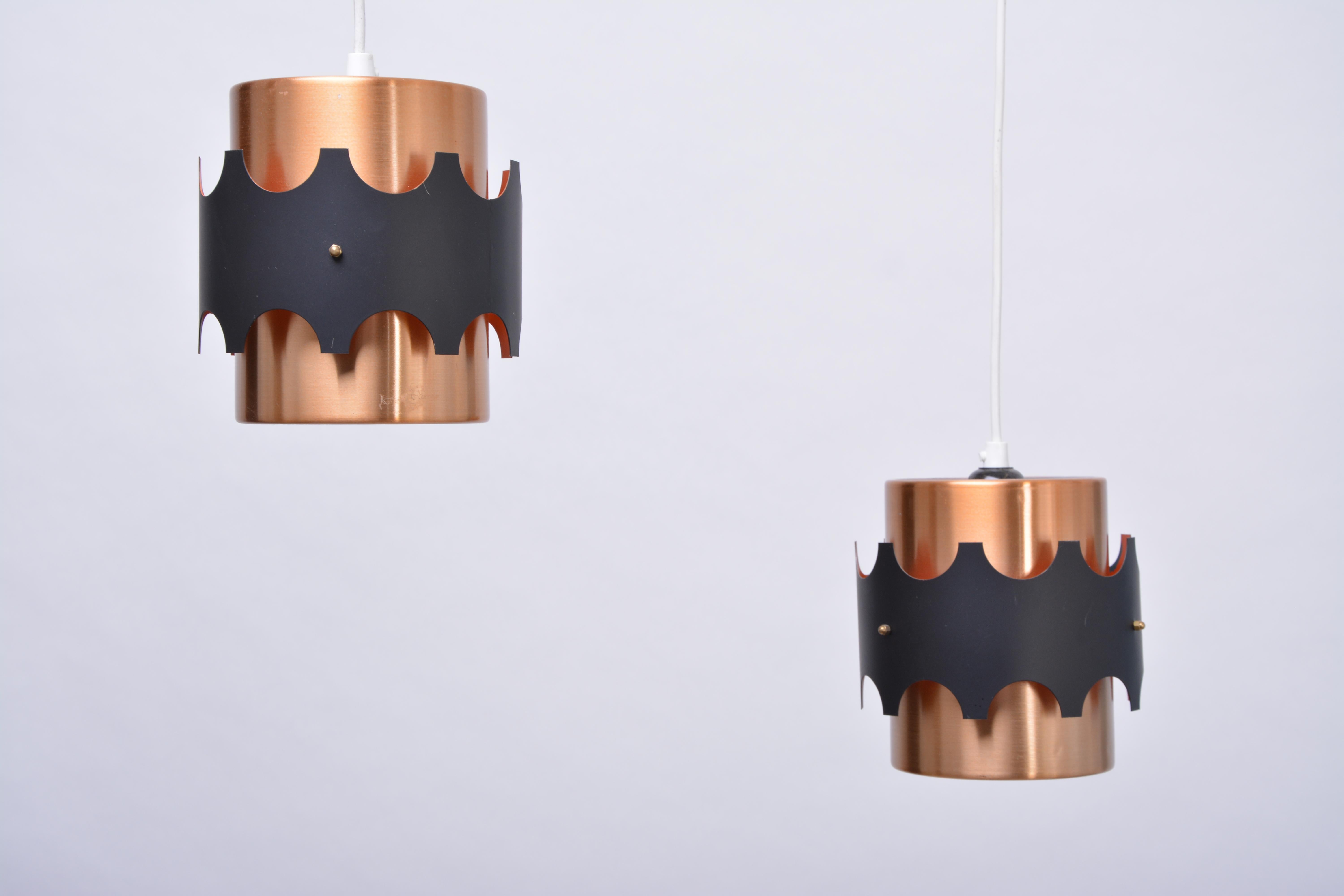 Pair of pendant lamps made of anodized aluminium made in East Germany in the 1960s. The design is similar to Jo Hammerborg.