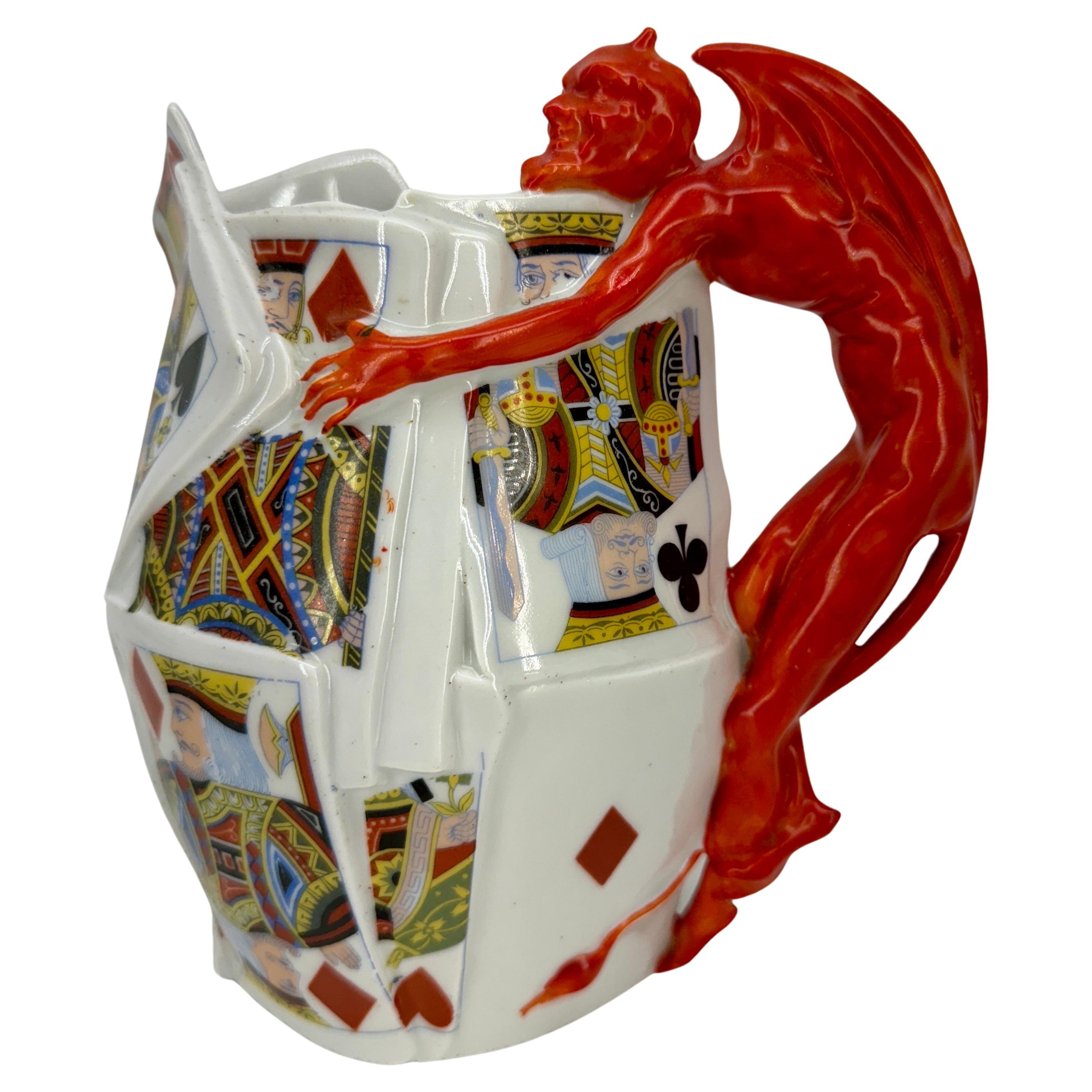 Super decorative set of German Royal Bayreuth Porcelain Jug and Jar Devil Cards

This Royal Bayreuth Pitcher and Lidded Jar is part of the Devil and Cards series and is known to be symbolic as it was considered a sin to play cards and gamble. This