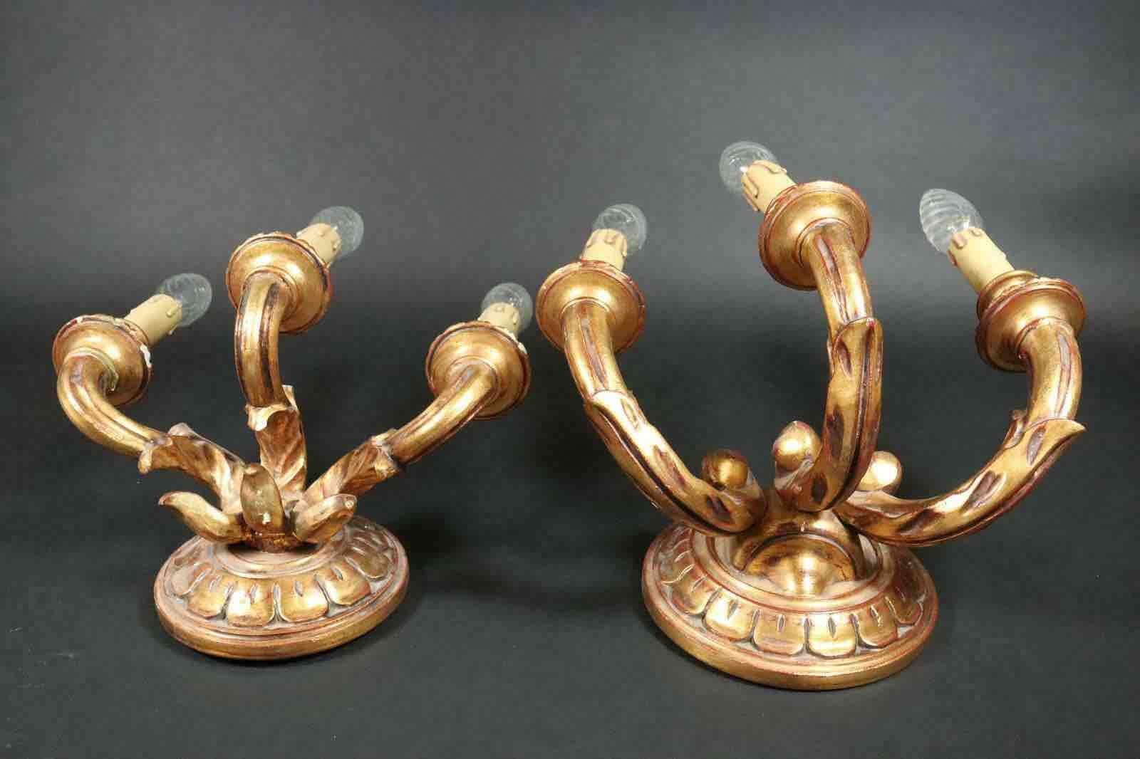 Add a touch of opulence to your home with this set of two charming sconces. Perfect gilt wood and stucco to enhance any chic or eclectic home. We'd love to see them hanging in an entryway as a charming welcome home. Built in the 1960s, in Italy,