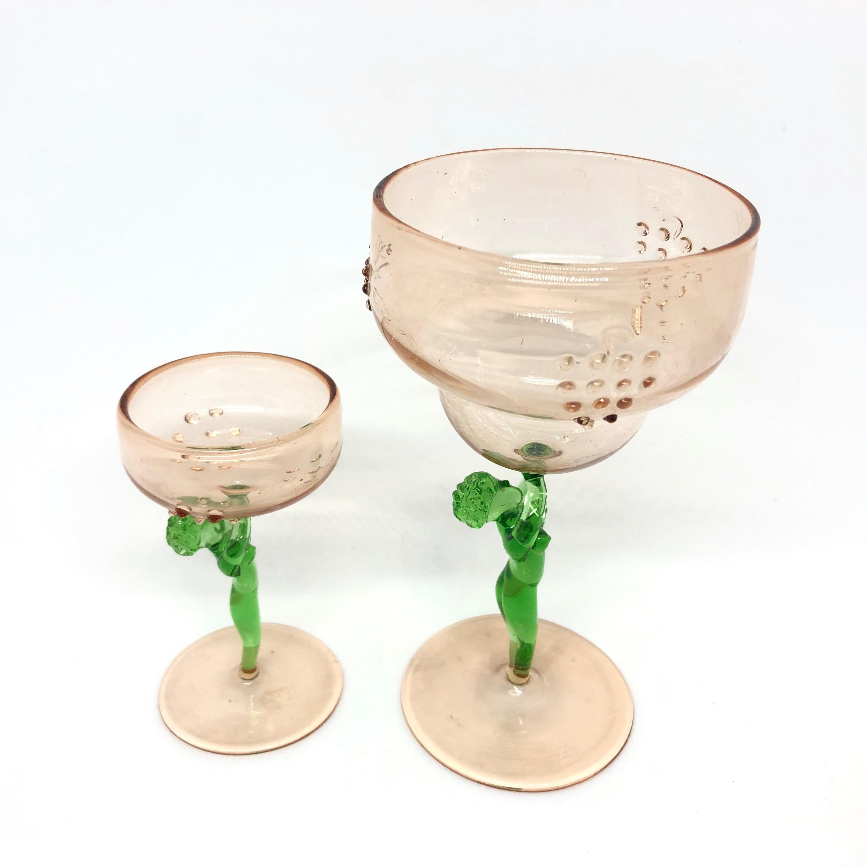 Set of two beautiful glasses with nude ladies as stems and a decanter made in the style of Bimini, Austria. Very good vintage condition, consistent with age and use. Small glass is approx. 3 3/8