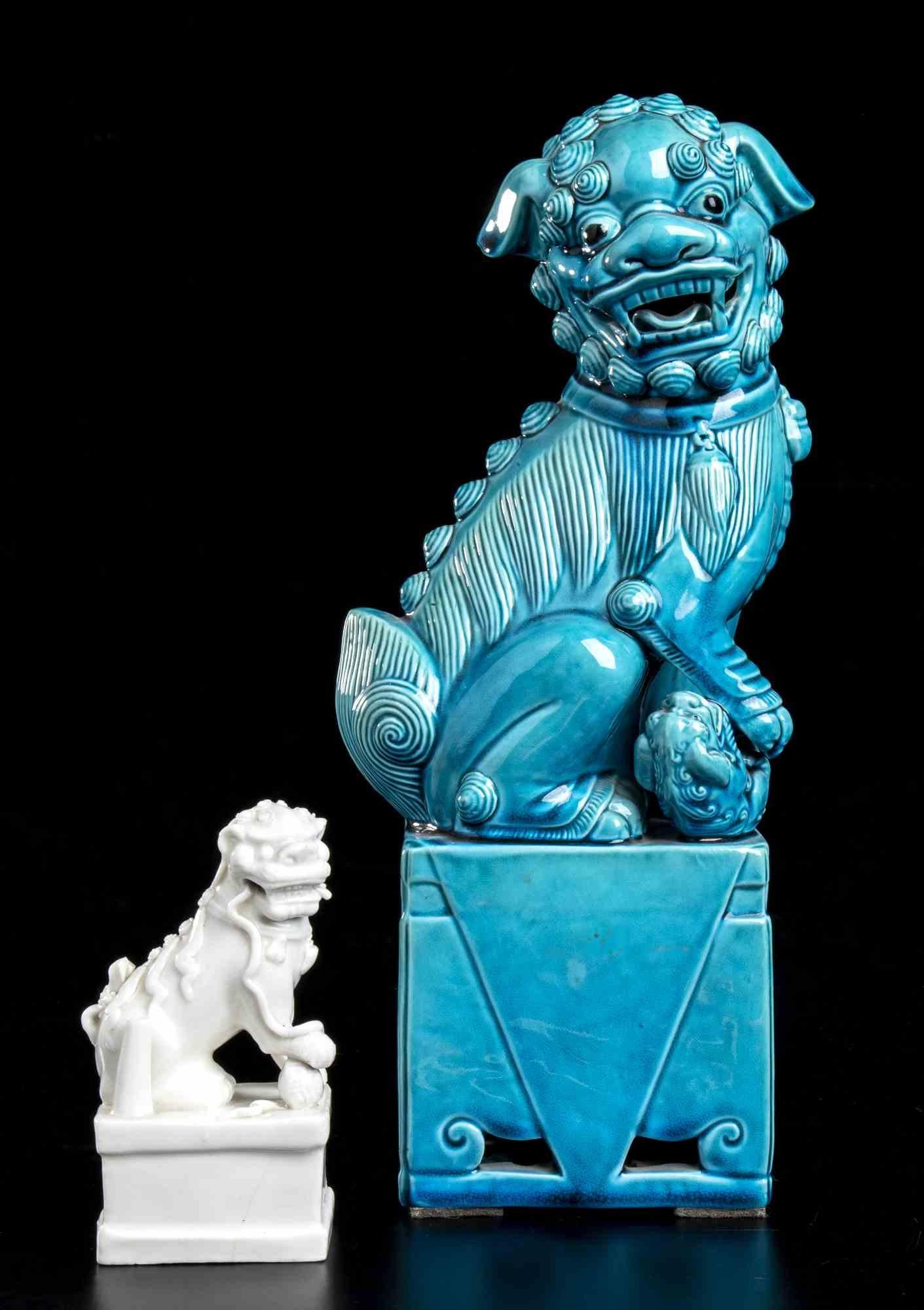 China, mid-20th century

Both seated on the hind legs on a rectangular section plinth, the right front paw resting on the ball symbol of the Void and the head turned to the right, the larger covered on the outside with a turquoise glaze, the