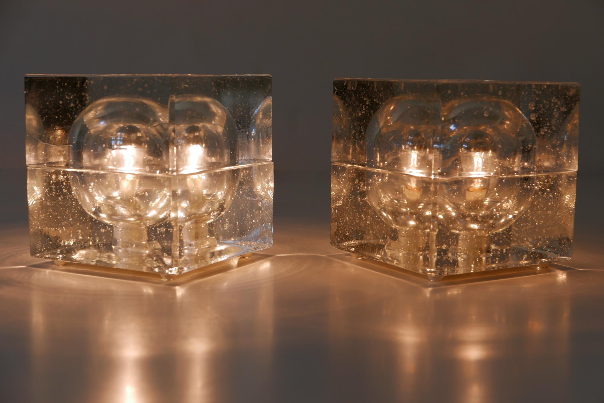 Set of two beautiful Mid-Century Modern hand blown ice glass table lamps in the style of Cubo Sfera by Allessandro Mendini. These ones are manufactured by Müller & Zimmer in 1970s, Stuttgart, Germany. One with makers label underside.

Executed in