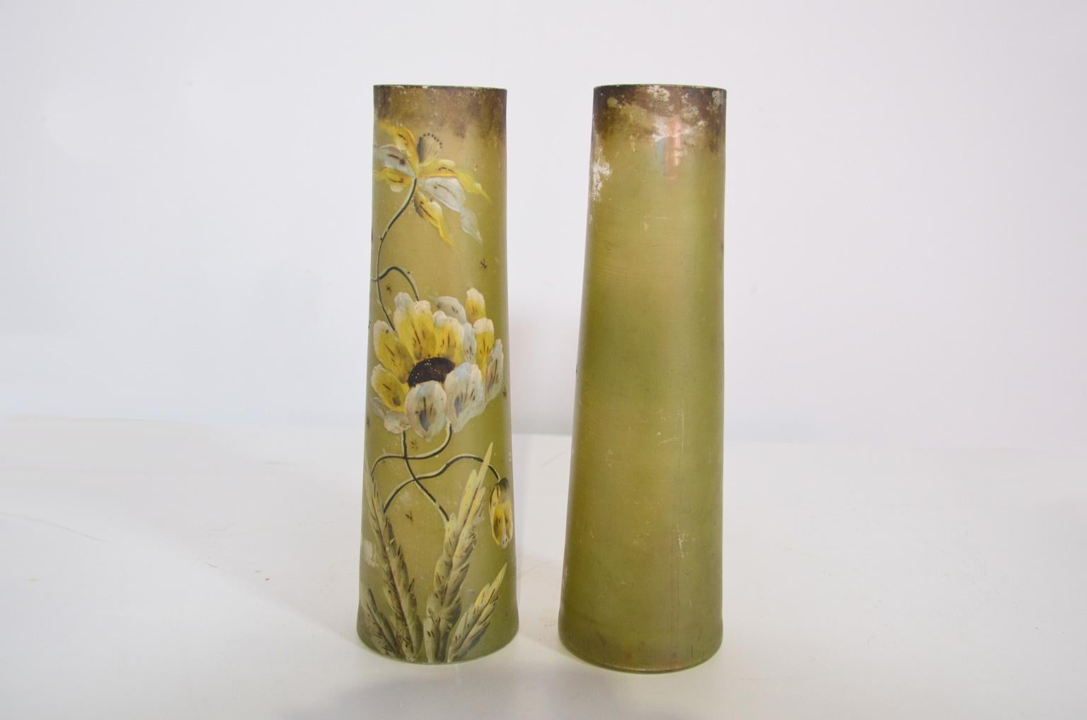 Hand painted glass vases with floral decoration against a green background. The decoration is only applied to the front side of the vase. Some parts have lost the decoration (images 7), close to the upper side of the vase.