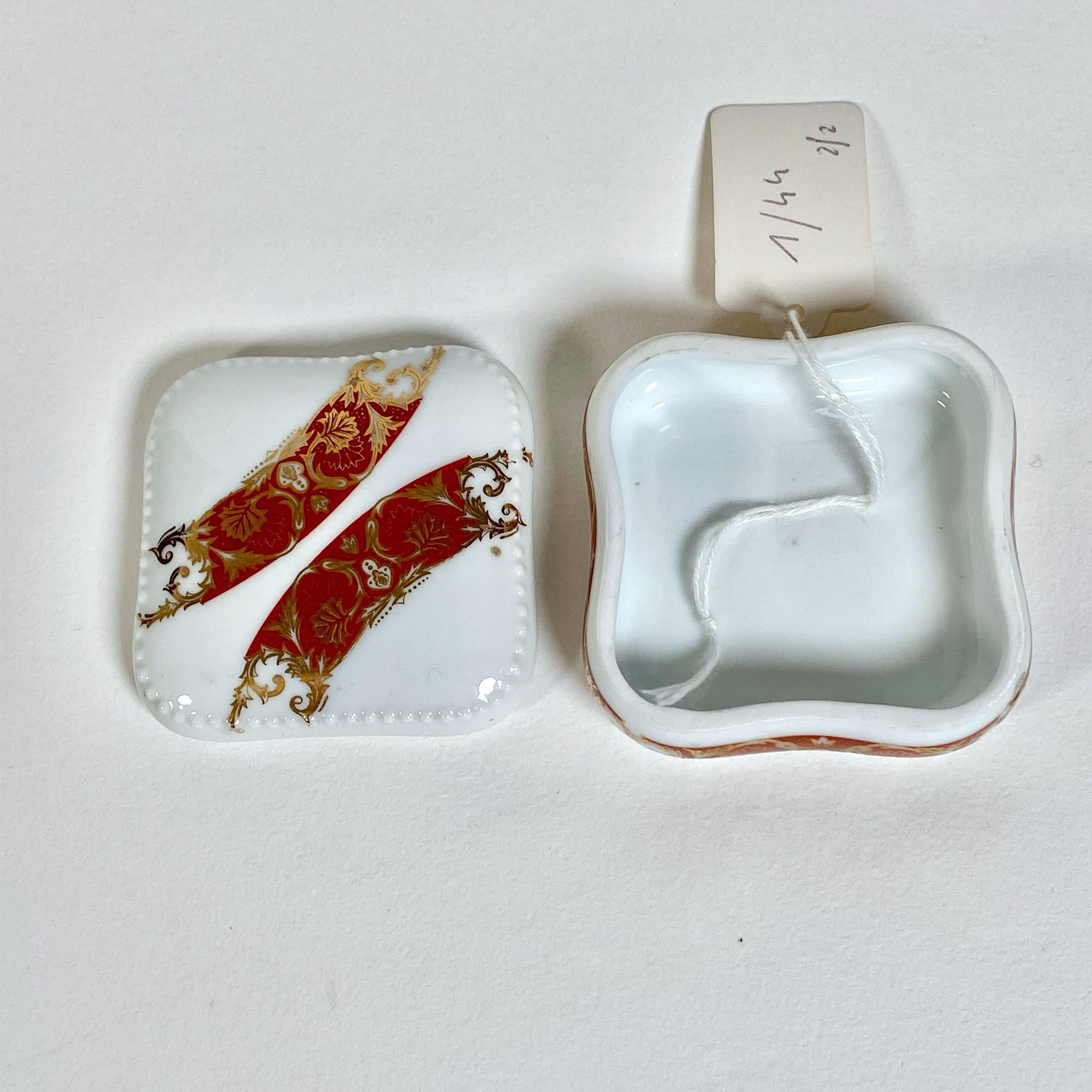This elegant set of two porcelain boxes, meticulously crafted by L’Ambaire, features the timeless quality of Limoges porcelain from France. Each box is square-shaped, measuring 6.5 cm wide and 3 cm in height, making them perfect for storing small