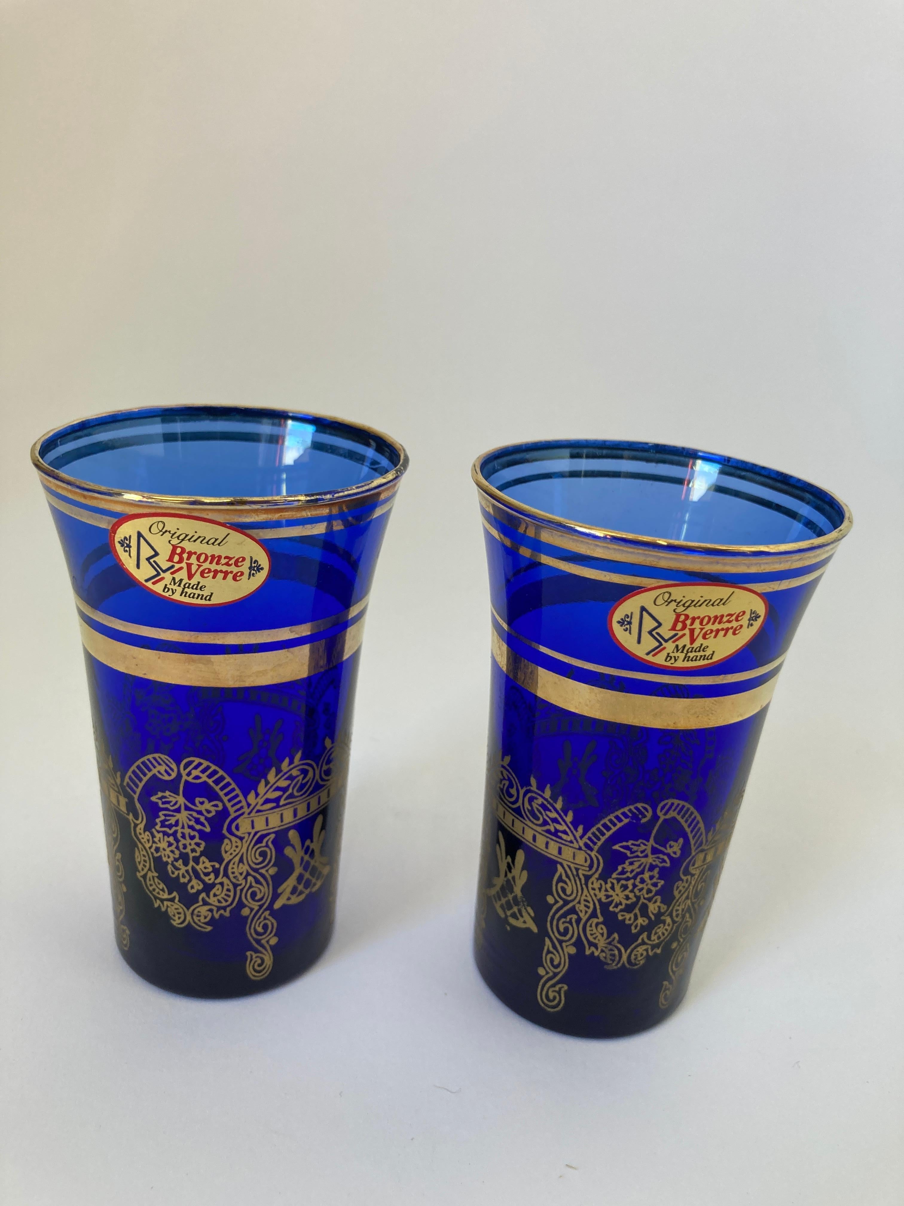 Set of 2 royal blue and gold handblown Moorish crystal cobalt blue drinking glasses.
Use them for or any hot or cold drink.
Elegant, classic barware shot crystal glasses very light finely decorated with a classical 22 karat gold Moorish overlay