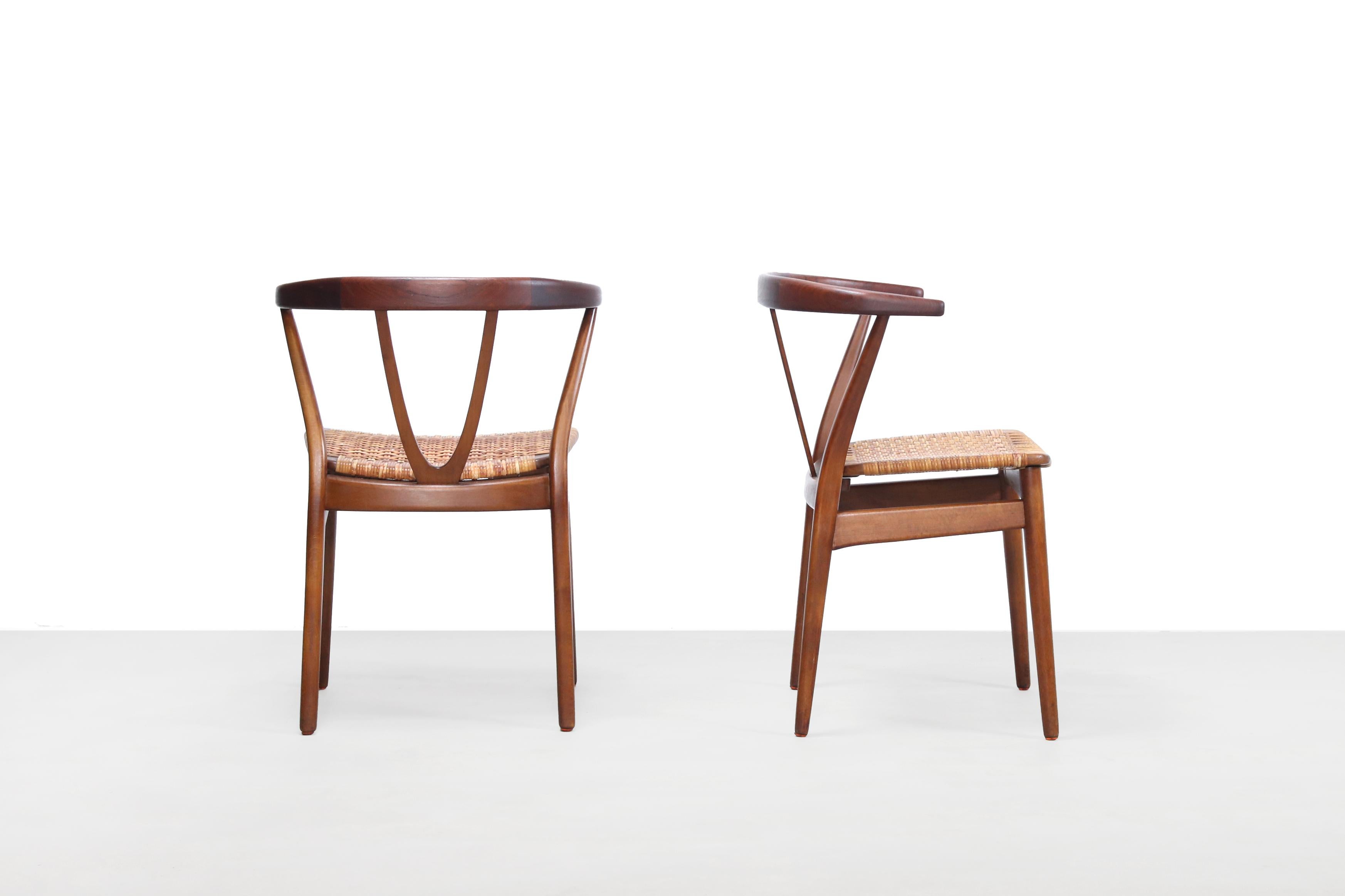 Two rare Scandinavian Modern hoop back chairs designed by Henning Kjaernulf for Bruno Hansen, Denmark in the 1960s. The Kjaernulf model 225 chair has clear references to the Hans Wegner wishbone chair. These chairs are made of solid teak with a