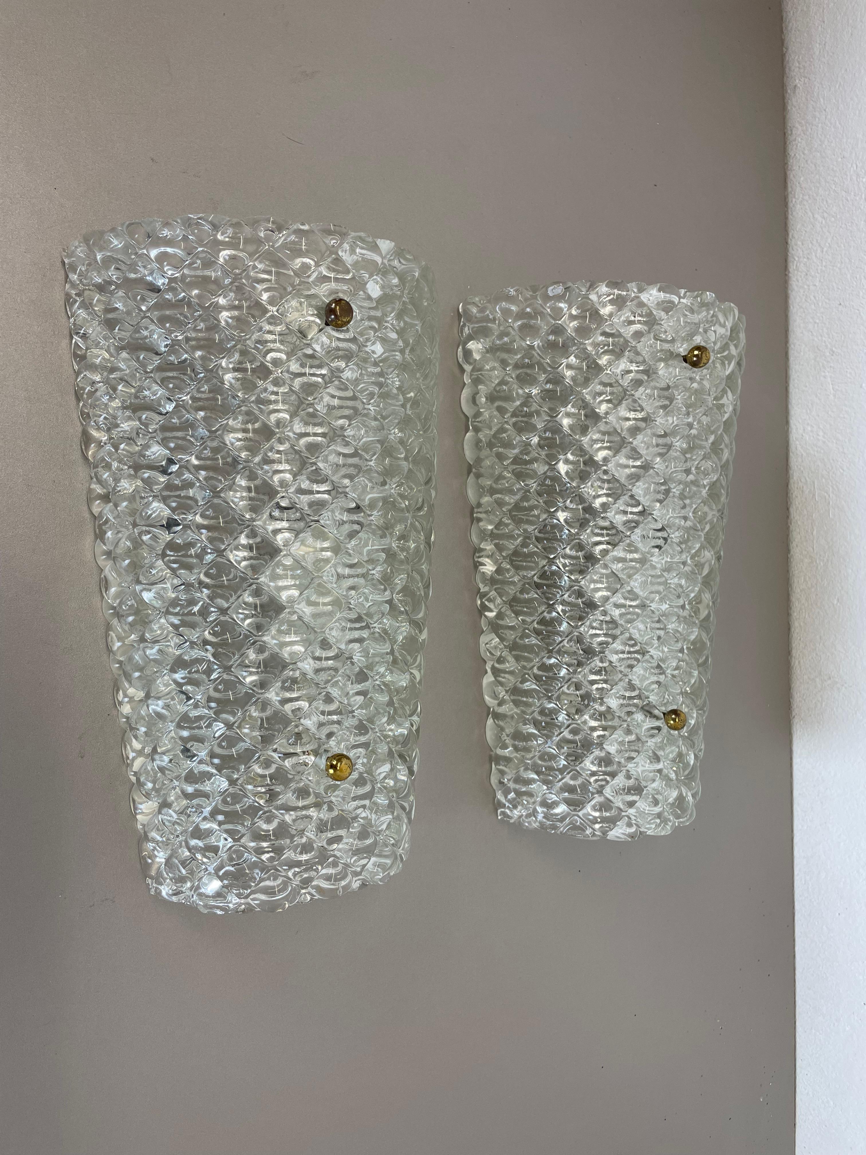 Article:

Set of two

Wall light sconces


Origin:

Austria



Age:

1950s



This set of two modernist lights was produced in Austria in the 1950s. It is made from heavy crystal glass with a abstract patterned structured surface and a metal wall