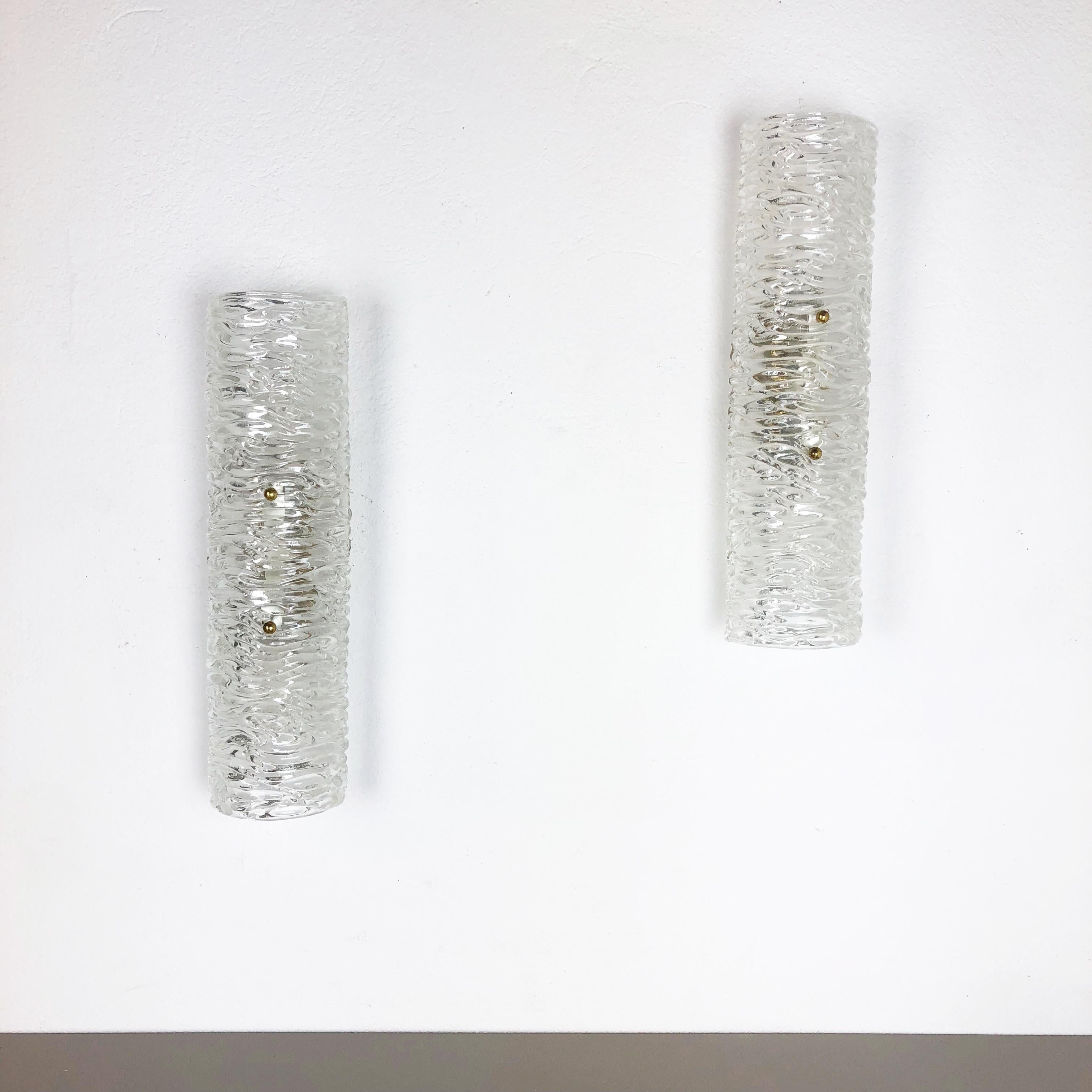 Article:

Set of two

Wall light sconces


Origin:

Germany



Age:

1970s



This set of two modernist lights was produced in Germany in the 1960s. It is made from heavy glass and has a metal wall fixation. The lights have a fantastic abstract and