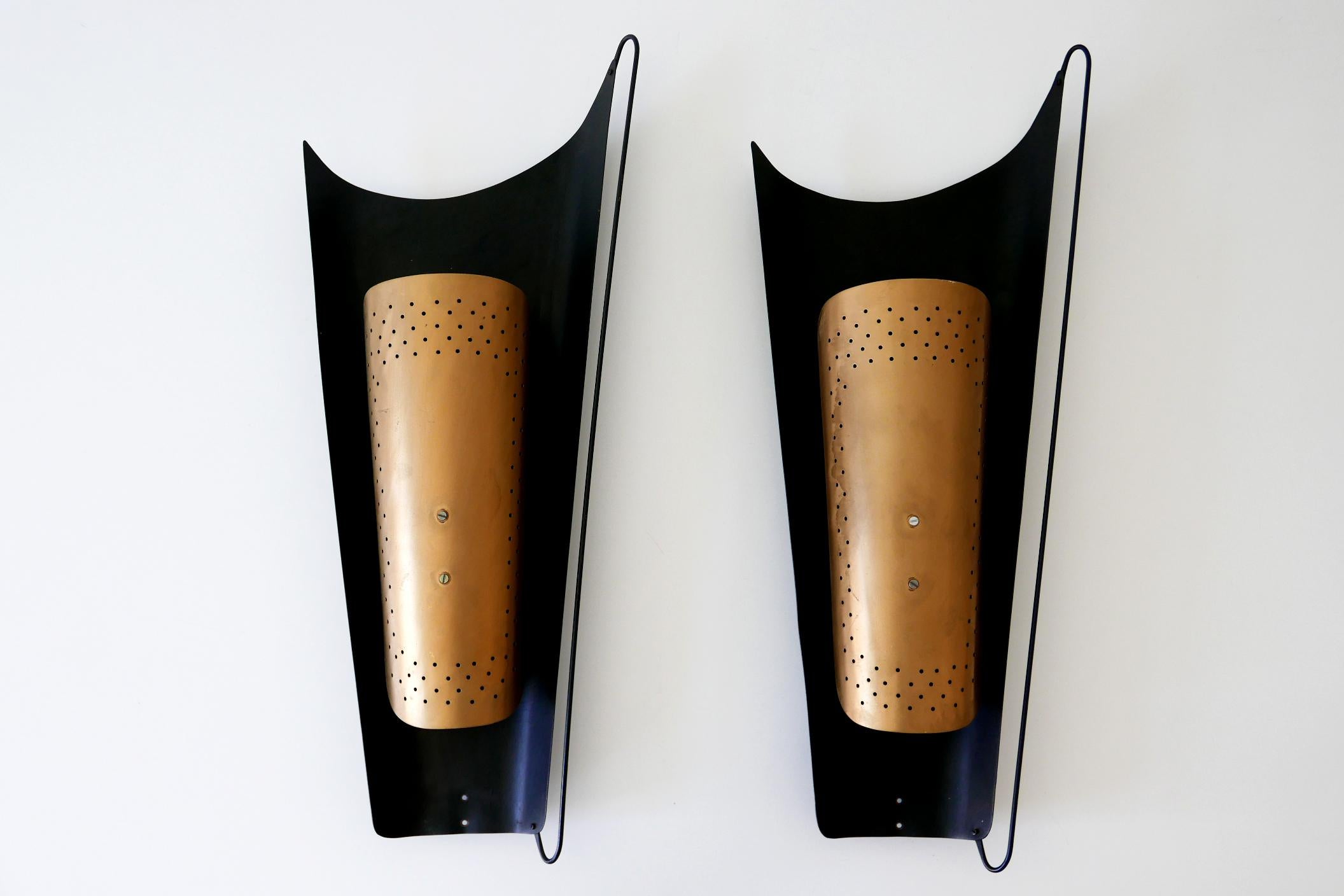 Set of two large and elegant Mid-Century Modern wall lamps or sconces. Designed and manufactured by Karl Walther Nachf., 1950s, Wurzen, East Germany. Each lamp with makers label reverse.

Two identical sets available!

Executed in black and gold