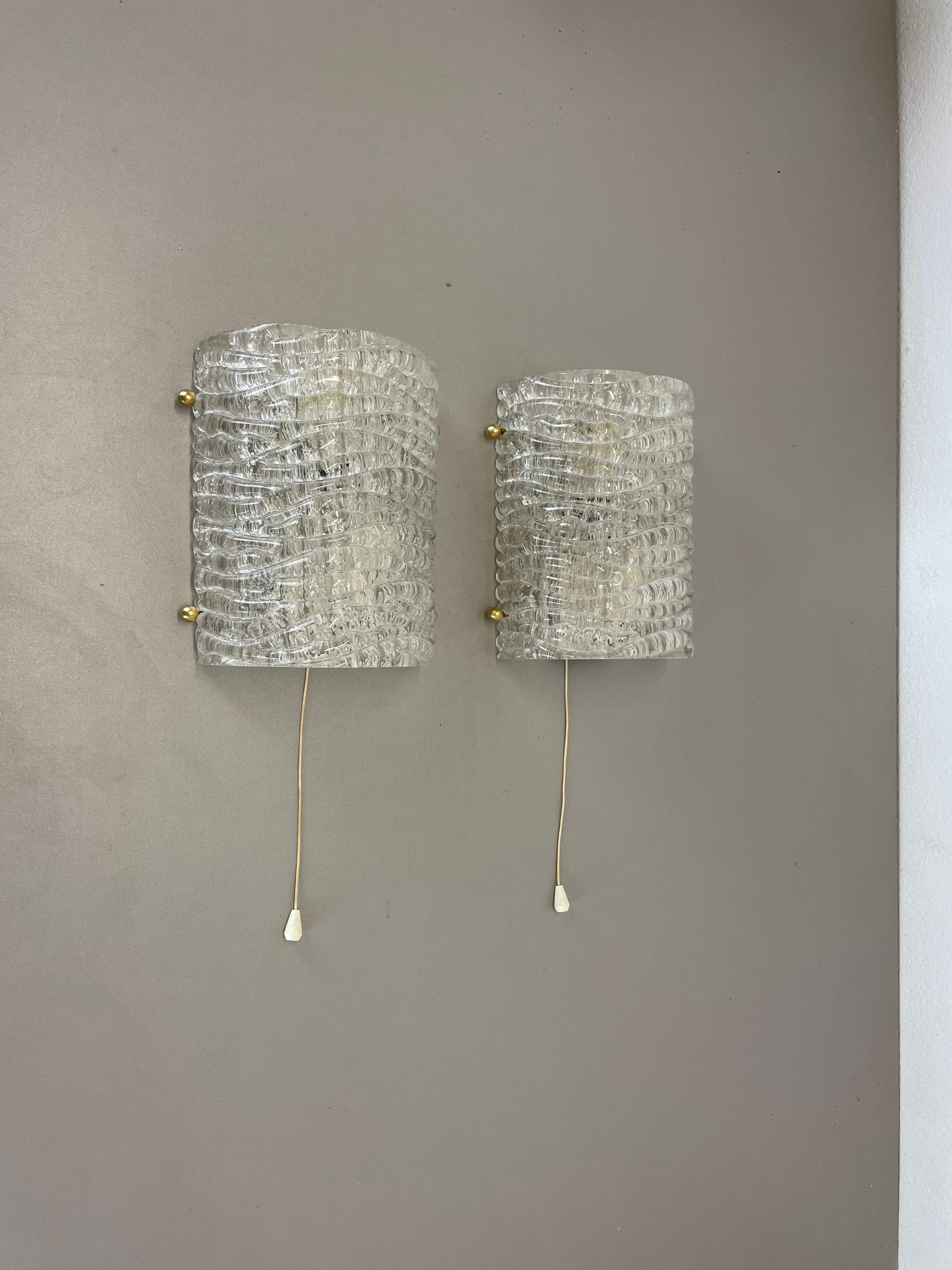 Article:

Set of two

Wall light sconces


Origin:

Germany



Age:

1970s



This set of two modernist lights was produced in Germany in the 1970s. It is made from heavy glass and has a metal wall fixation. The lights have a fantastic abstract and