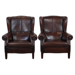 Used Set of two in very good condition dark sheepskin leather wingback armchairs