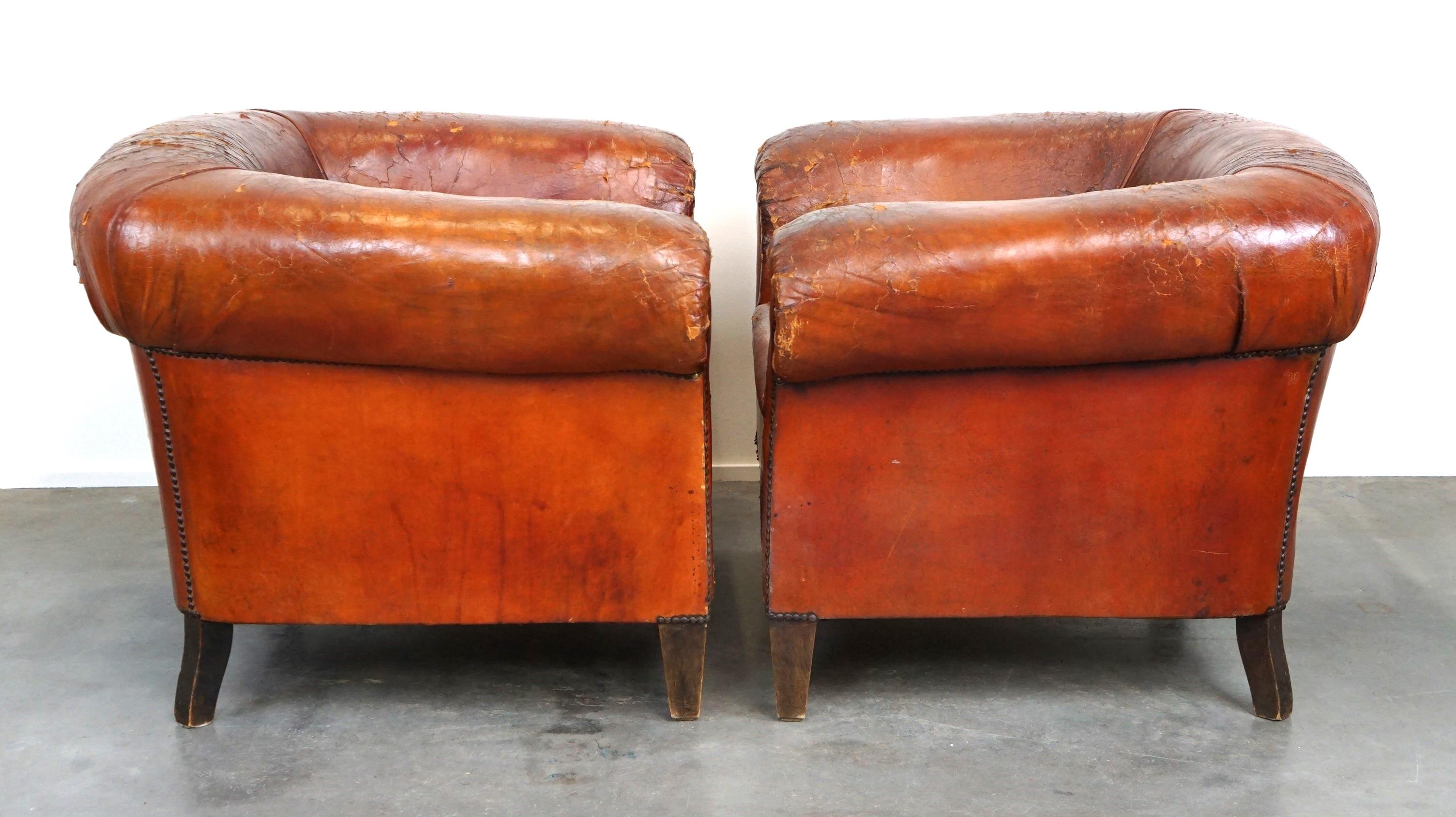 Offered: this unique set of two incredible antique leather club armchairs with a stunning patina.

This unique set has acquired a wonderful weathered appearance over time, and so have their seats. It's evident that you won't be the first to sit in