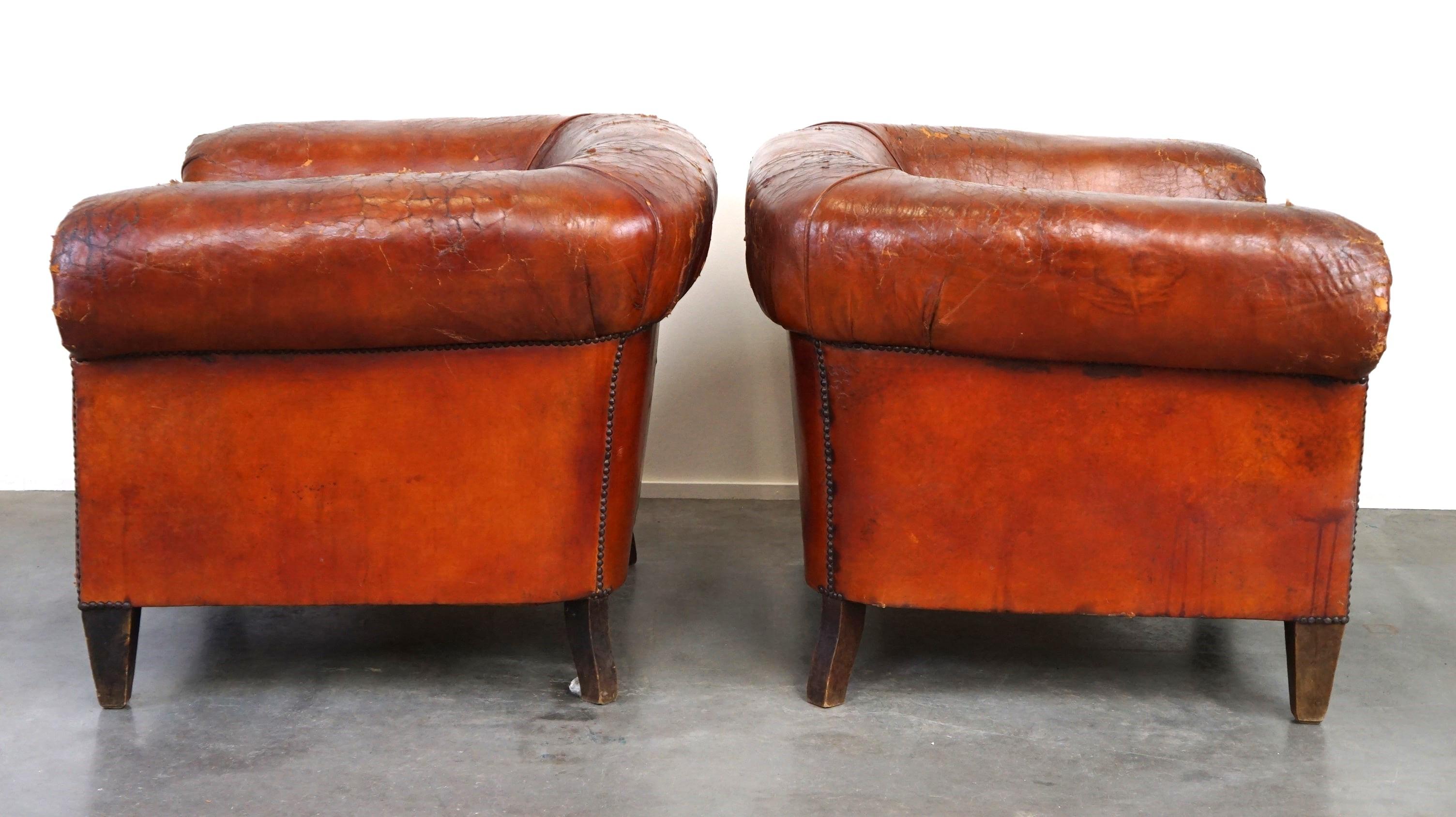 Hand-Crafted Set of two incredible antique leather club armchairs, boasting a stunning patina For Sale