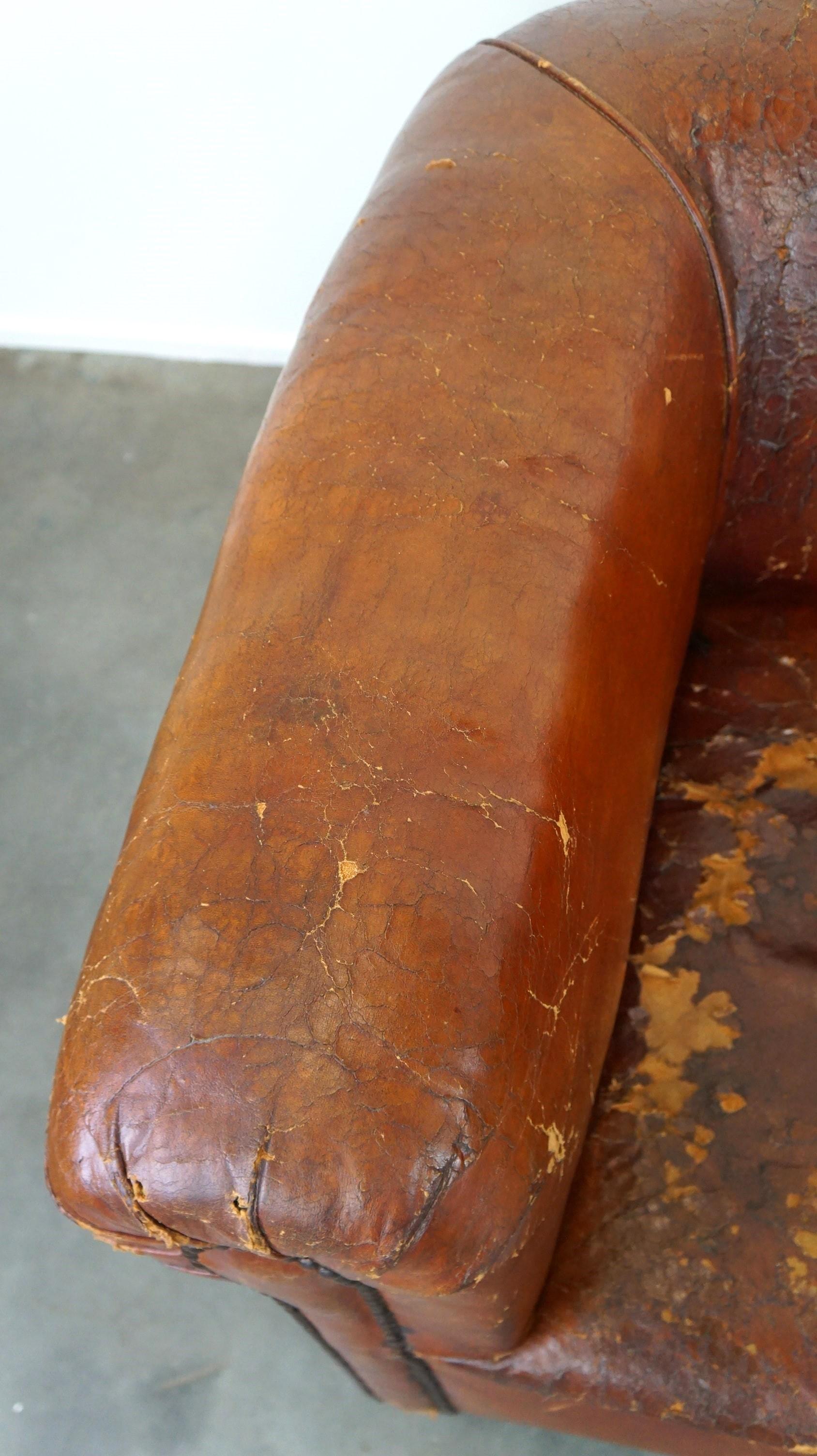 Leather Set of two incredible antique leather club armchairs, boasting a stunning patina For Sale