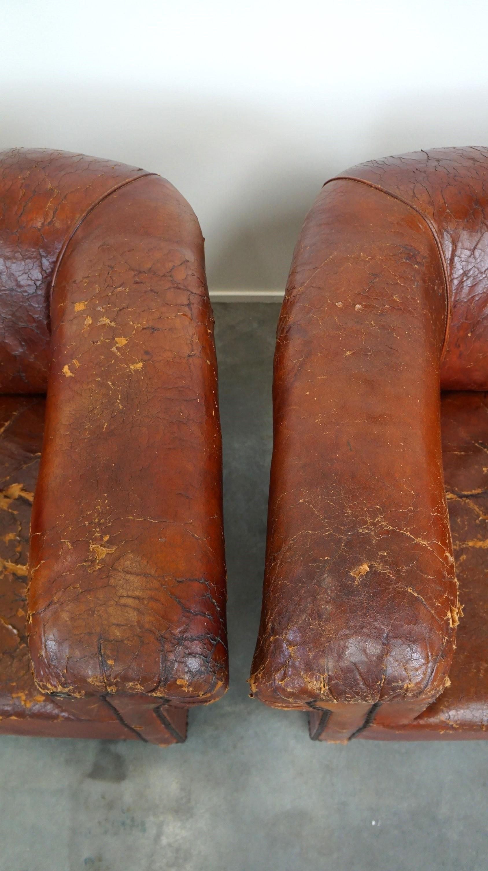 Set of two incredible antique leather club armchairs, boasting a stunning patina For Sale 1