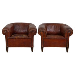 Set of two incredible antique leather club armchairs, boasting a stunning patina