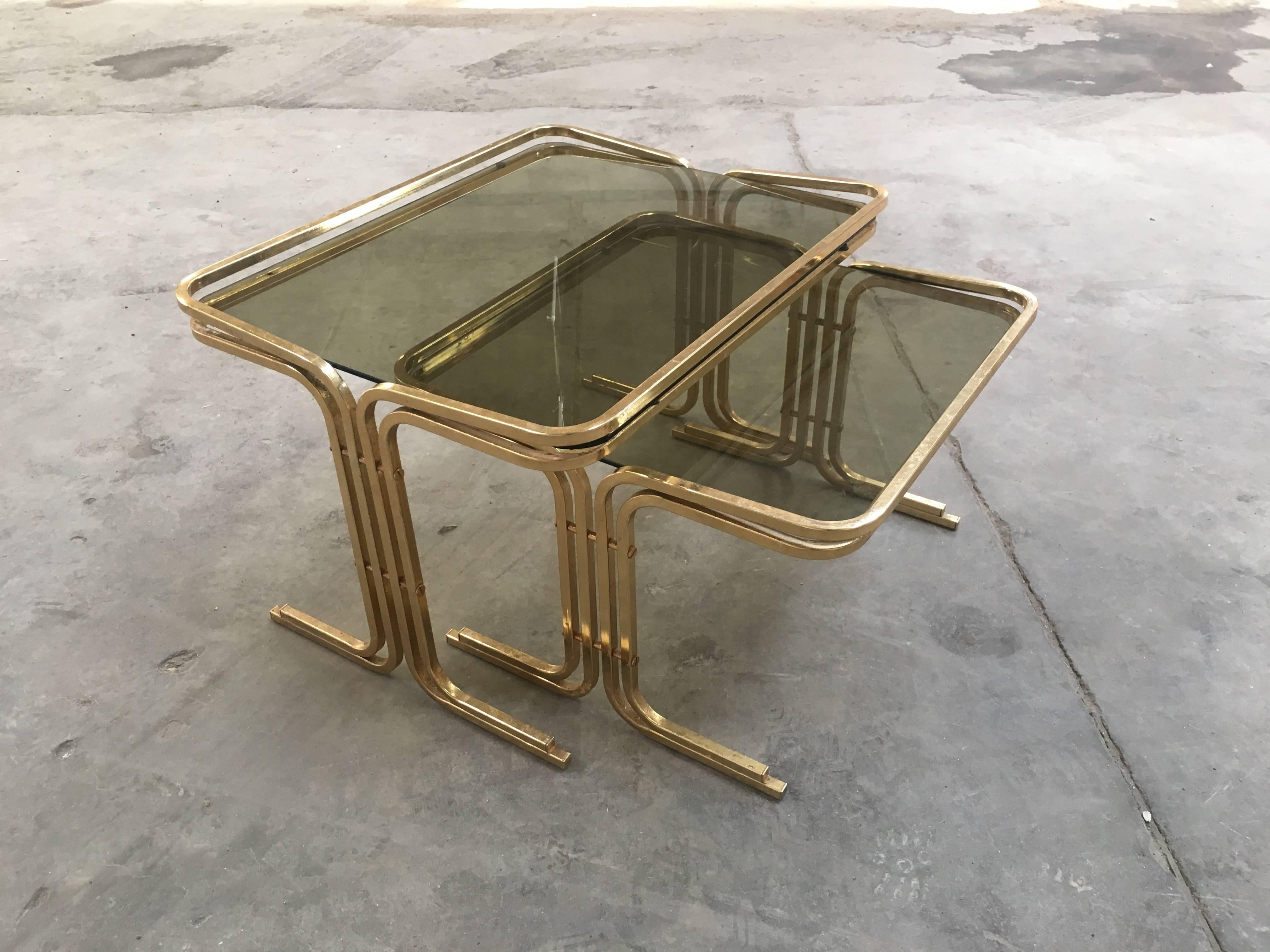 Set of two Italian brass or gilt metal nesting table with smoked glass top from 1970s
Measurements:
small cm 48 x 48 x H 33
big cm 48 x 60 x H 39
Very good conditions. Wear consist with age and use.
        