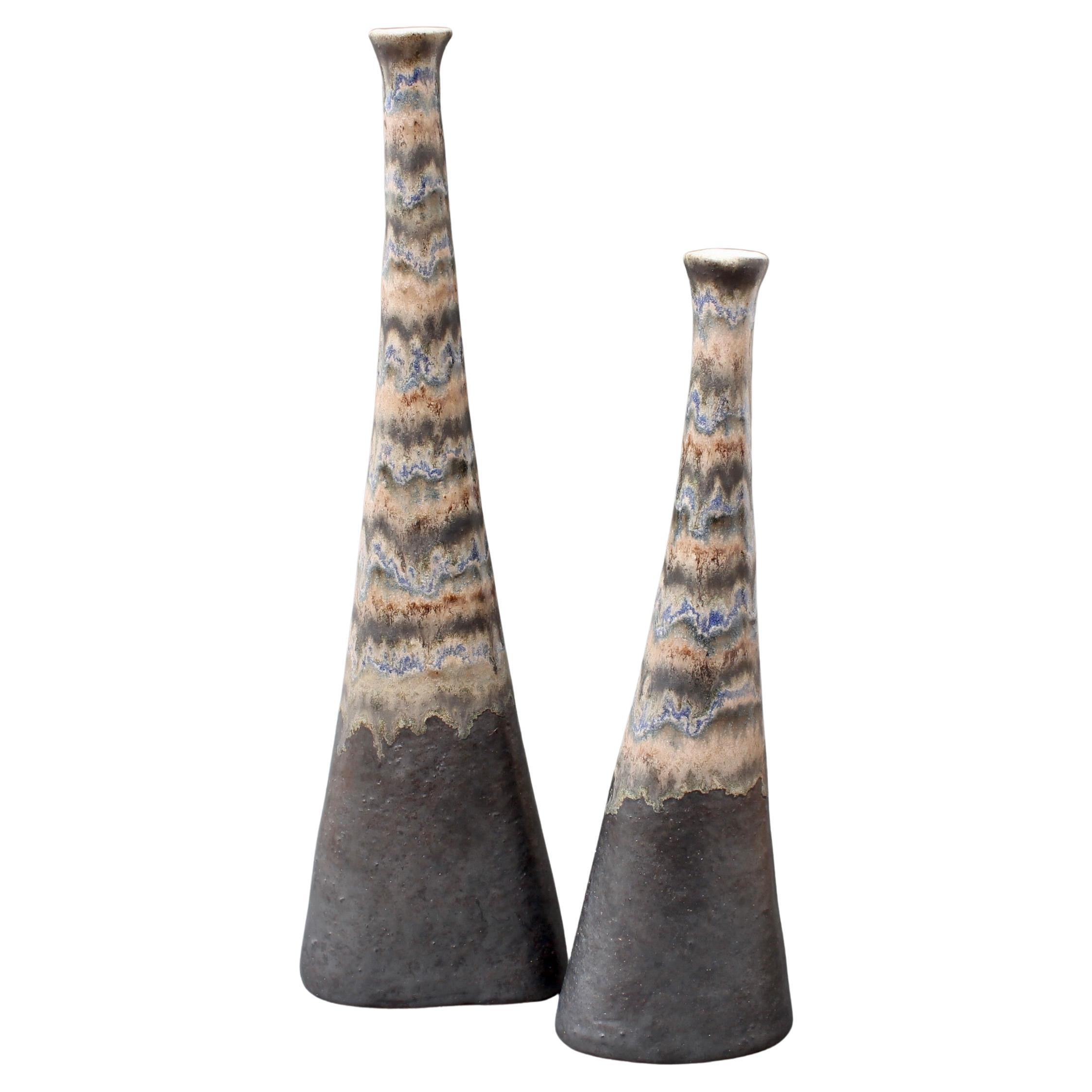 Set of two ceramic vases by Italian ceramicist Bruno Gambone, (circa 1980s). These very graceful, narrow-opening flower vases are works of art. They are visually stunning and tactile. The beautiful enamel finish is a dark brown mat at the base