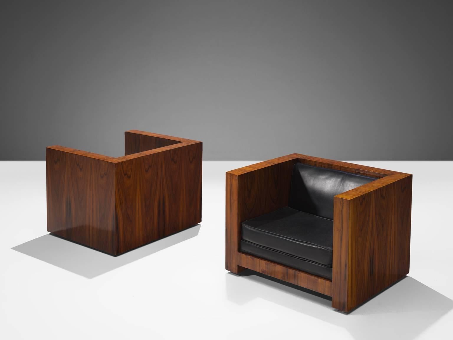 Two armchairs, black leather, rosewood, Italy, circa 1965

This set of two 'basket' lounge chairs are designed around 1965. The two leather cushions fall perfectly in the rosewood frame. The design of this chair is very geometric as the sides of