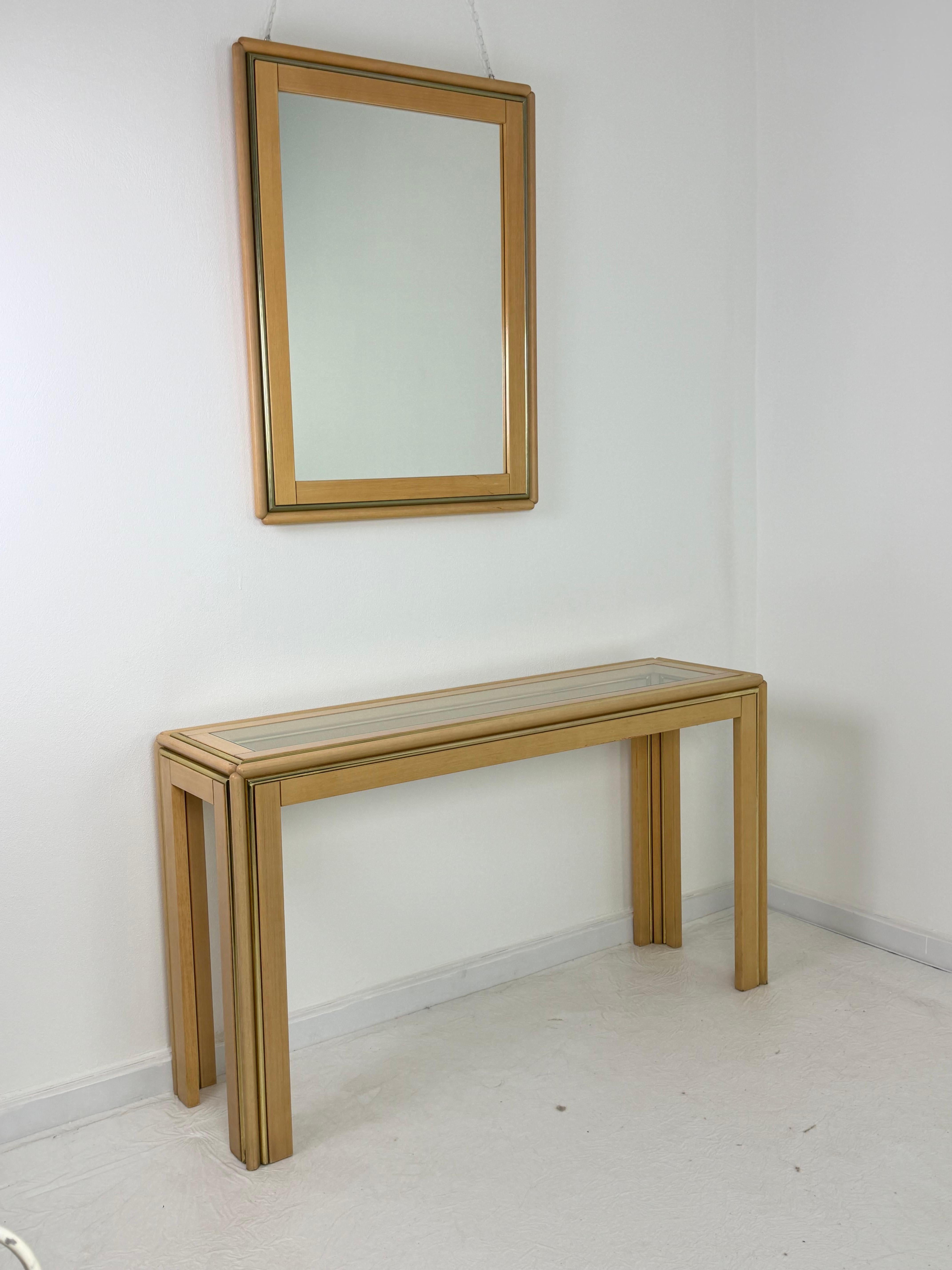Set of two Italian console tables and a mirror attributed to Aldo Tura, 1970s
Clean and elegant lines, gold-plated metal inserts.
Good condition, with minimal signs of aging.

The console table measures 130 cm x 37 cm x 74 cm high.
The mirror