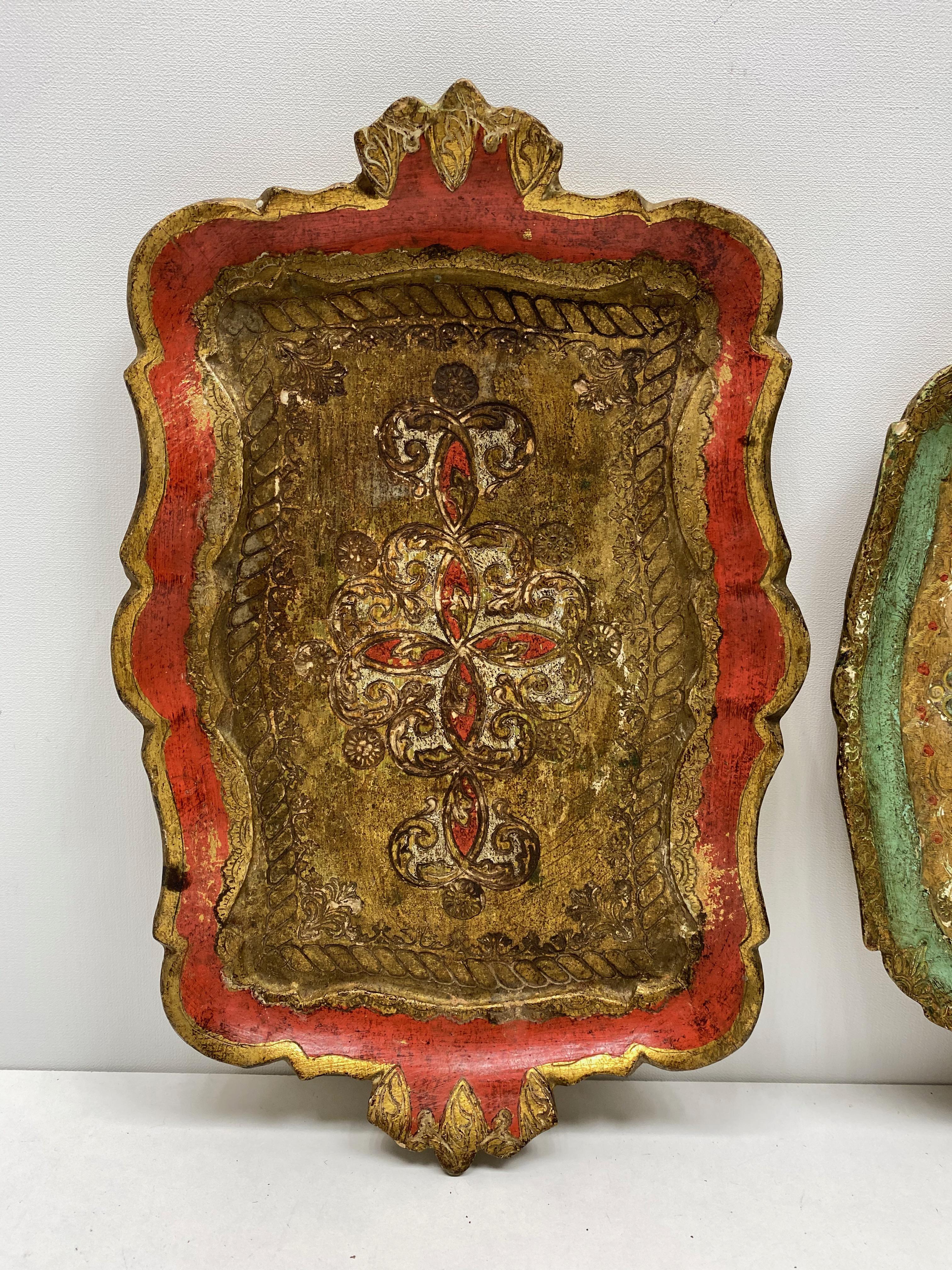 Offered is a set of two absolutely stunning, 1960s Italian giltwood petite serving trays. Minor patina and paint lost gives this pieces a classy statement. The red one measures approx. 1.25
