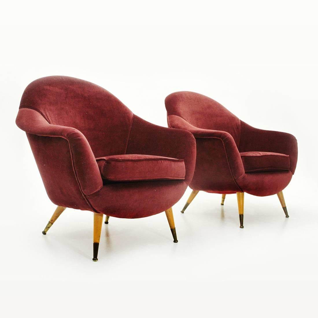 Pair of Italian manufacturing armchairs produced in the 1950s.
Wooden structure padded and lined with new burgundy velvet fabric.
Wooden legs with conical shape and brass tip.
Good general conditions.

Dimensions: Width 85 cm, depth 75 cm,