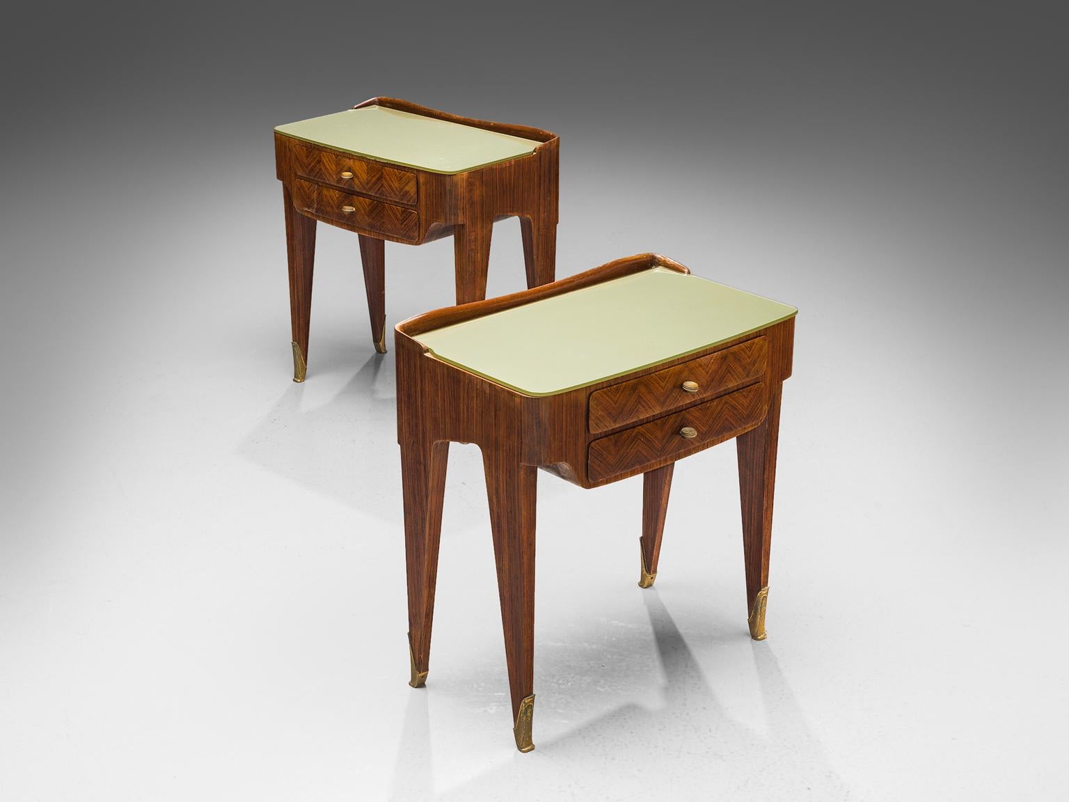 Nightstands, rosewood, glass and brass, Italy, 1950s.

These two side tables or nightstands are both refined and elegant in every way. The glass top falls perfectly on the top and is supported by precisely crafted legs. These sculptural Italian
