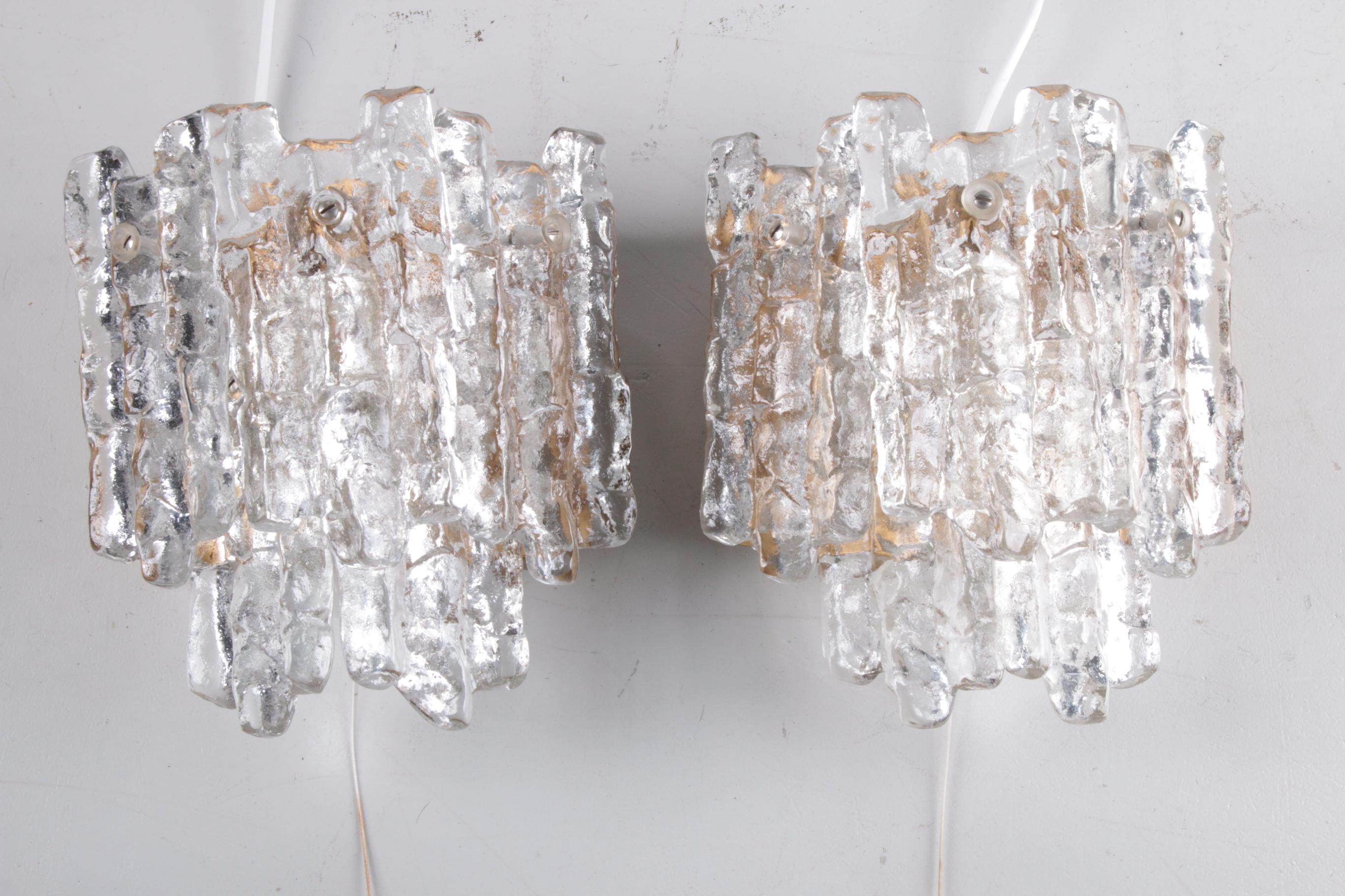 Set of two J. T. Kalmar ice glass wall lamps, 1960


Beautiful and elegant modern brass wall lamps or sconces, manufactured by J.T. Kalmar Austria in the 60's. Beautiful design, executed to a very high standard. Five solid ice glass plates dangle